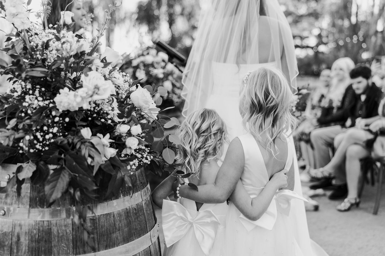 Black and white candid wedding celebration photos showing joyful moments and floral decorations.