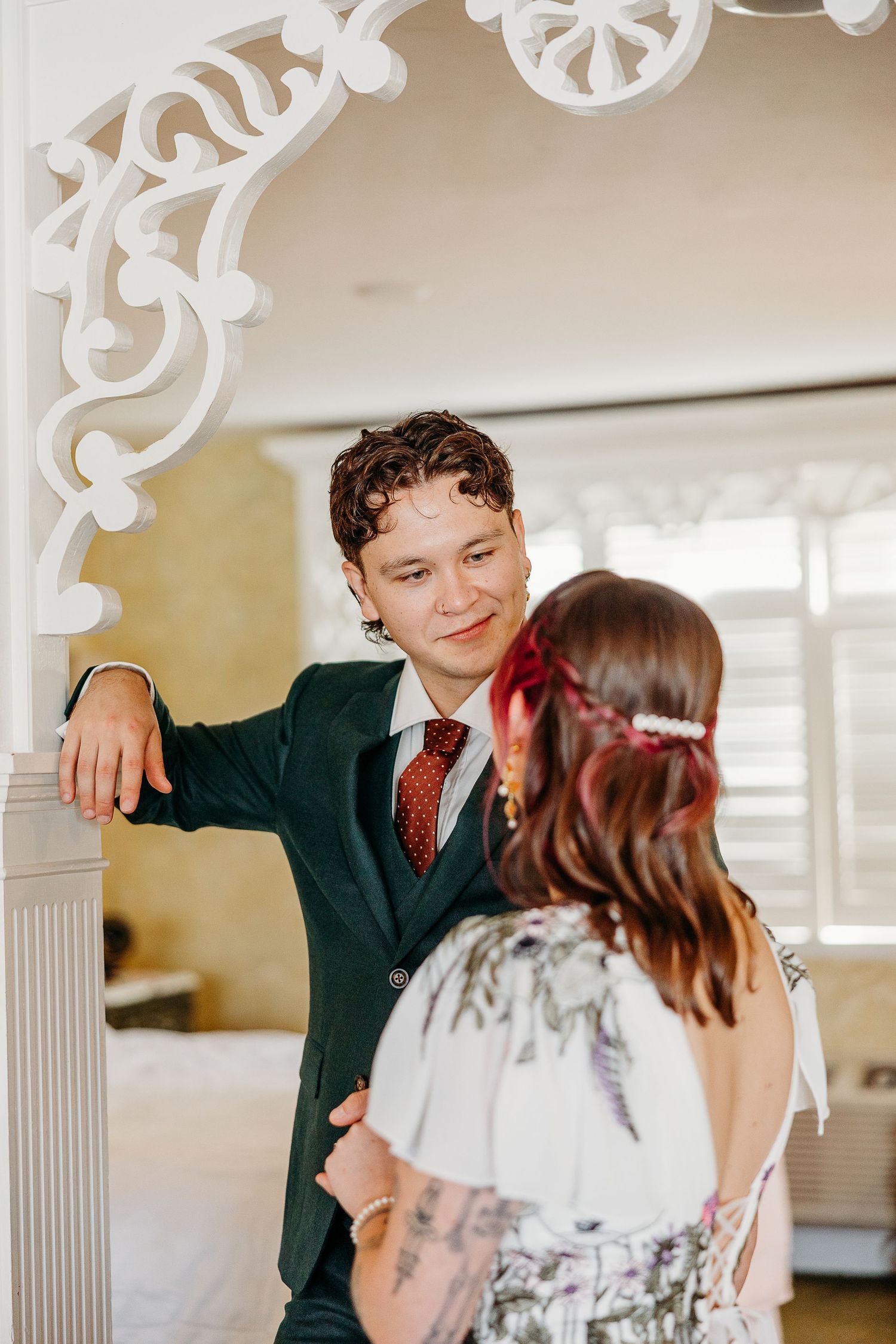 A romantic wedding moment captured in an elegant white-trimmed interior.