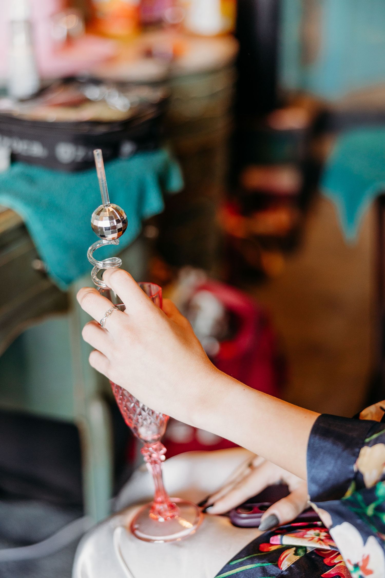 Close-up shot of hands holding jewelry during wedding preparations.