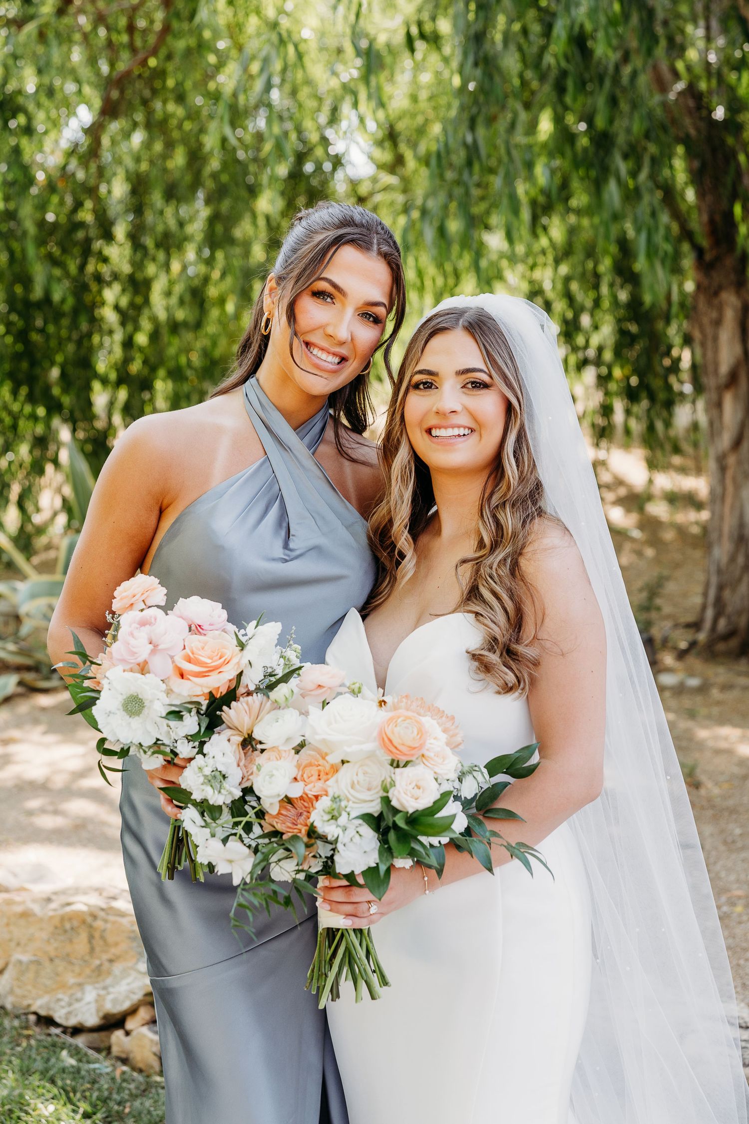 Candid wedding party photos showing bride and bridesmaid in gray dress holding peach and white bouquets outdoors.