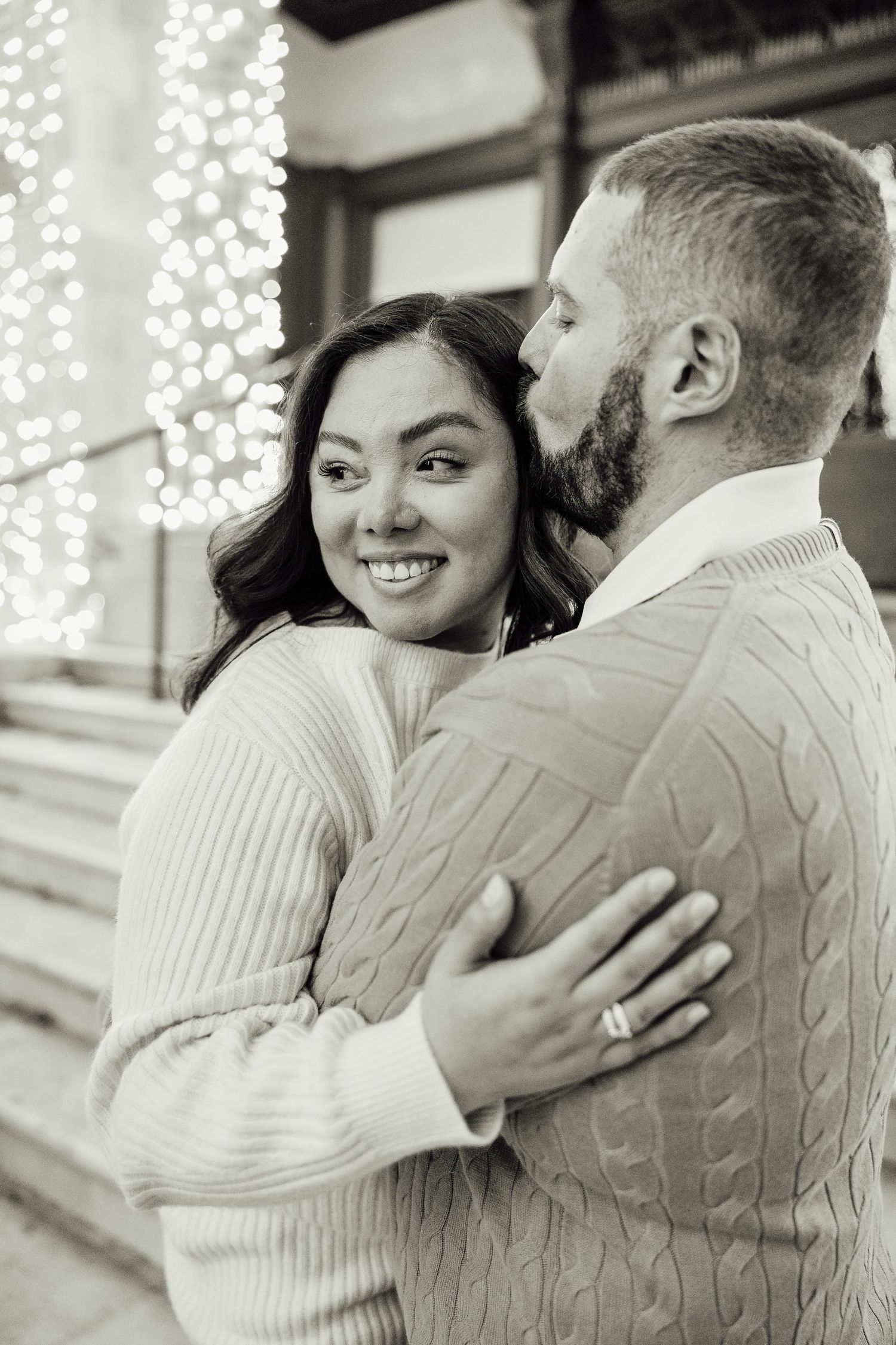A romantic black and white photo sequence showing a couple embracing and sharing tender moments together.