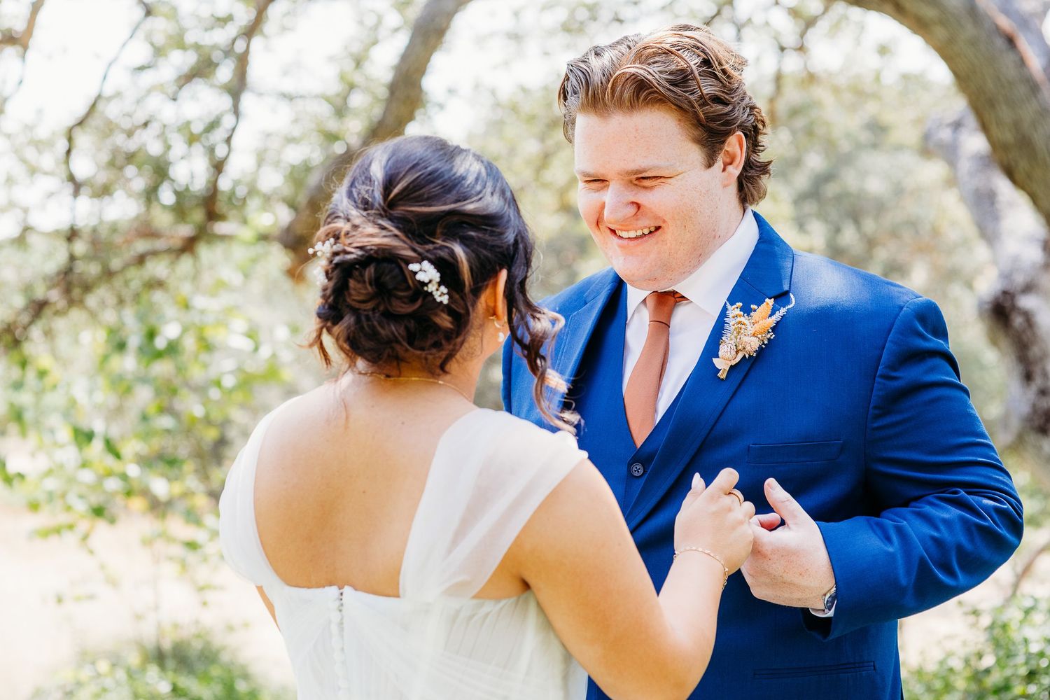 Couple shares a lighthearted moment during their outdoor wedding celebration.