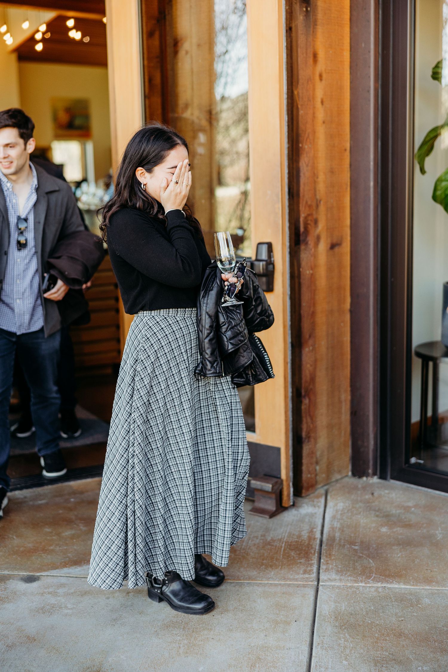 A surprised reaction captured in front of a rustic wooden doorway.