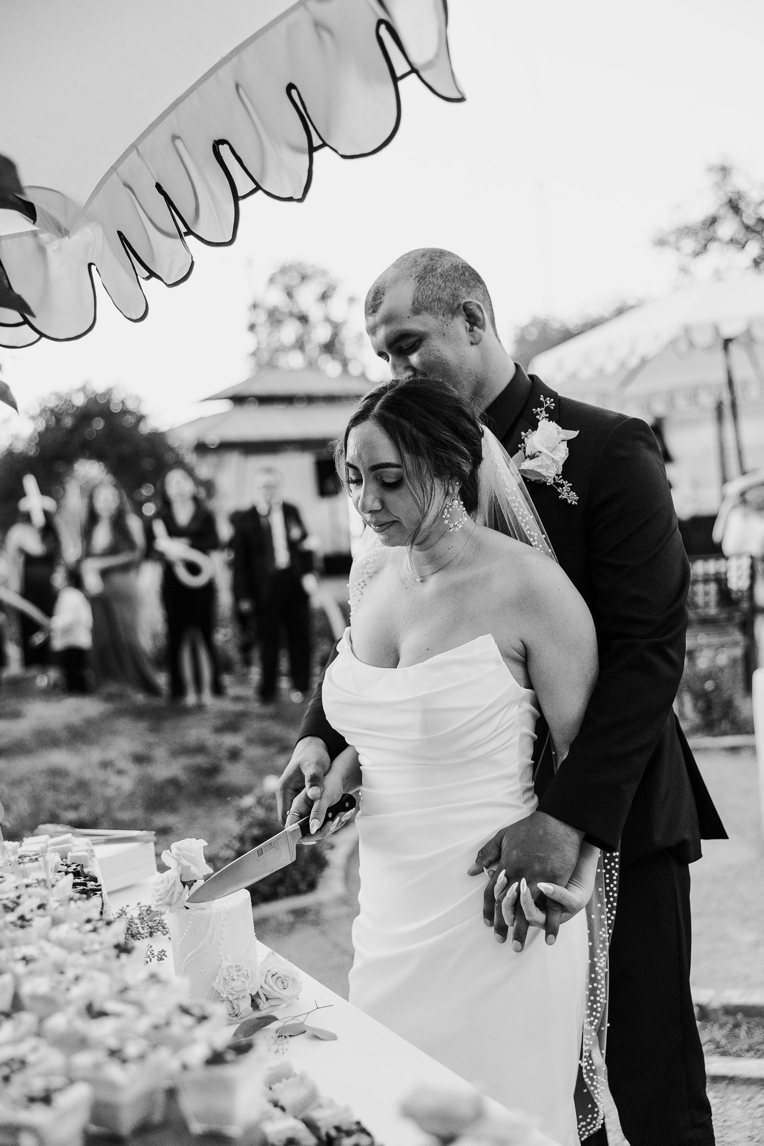 Black and white series of couple dancing together at outdoor wedding reception.