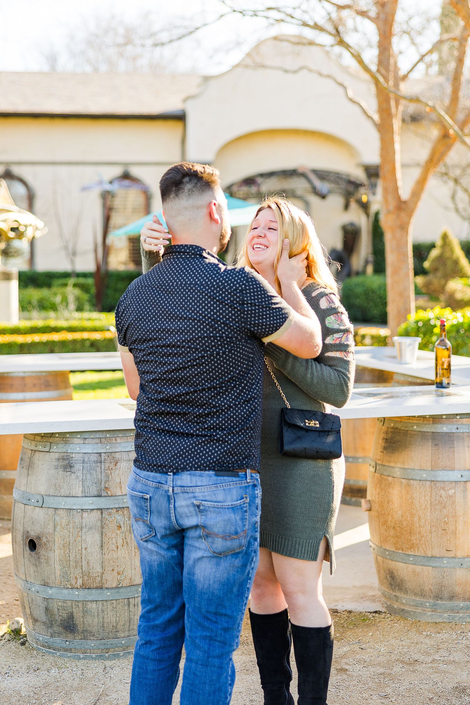 An intimate moment shared between two people at a winery's outdoor tasting area.