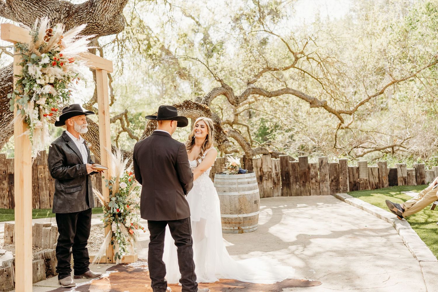A couple walks beneath majestic oak trees draped with Spanish moss.