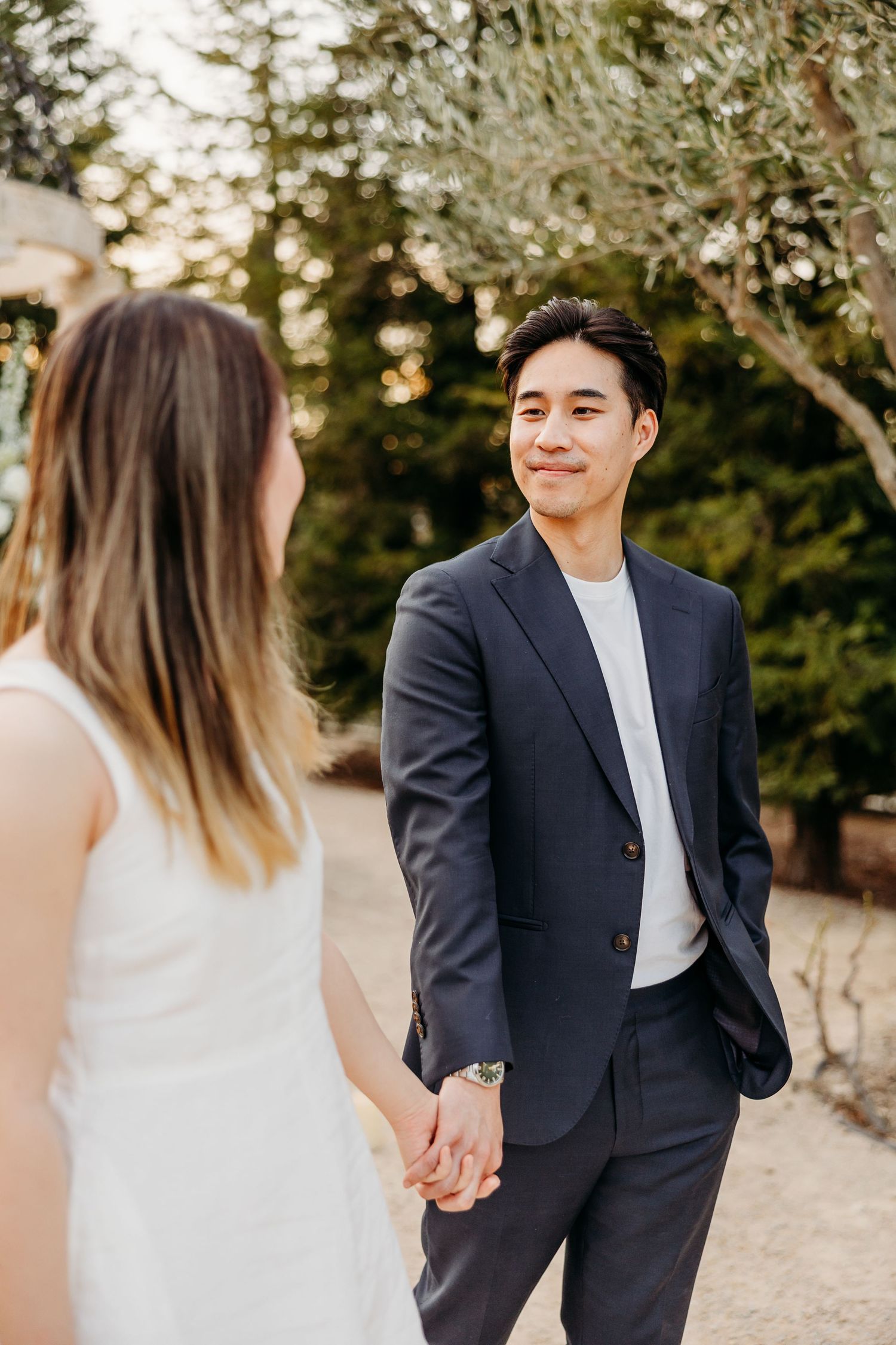 Candid moments between couple walking together during outdoor engagement session.