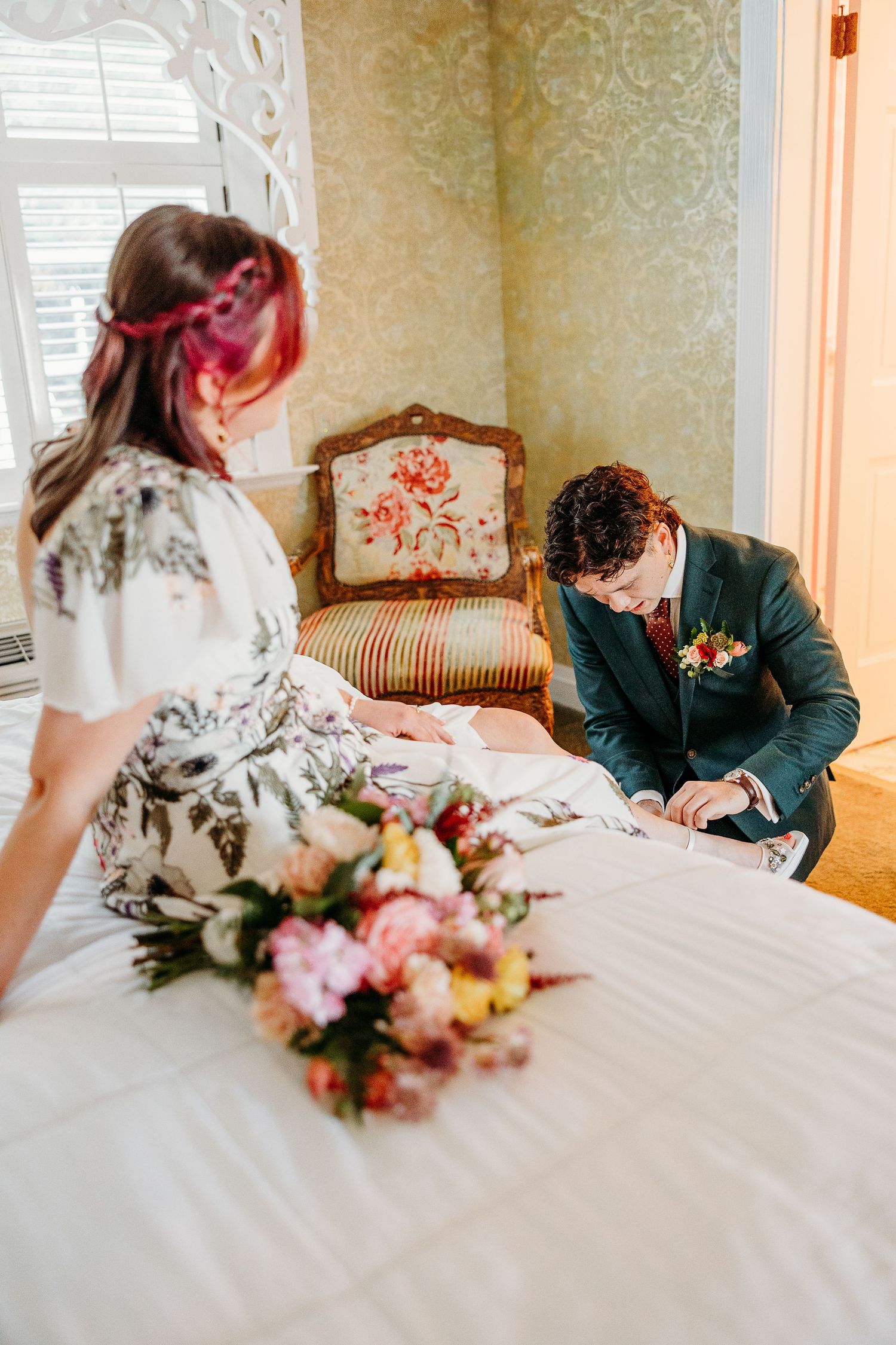 Wedding reception scene with white tablecloth, floral centerpiece, and vintage furniture.
