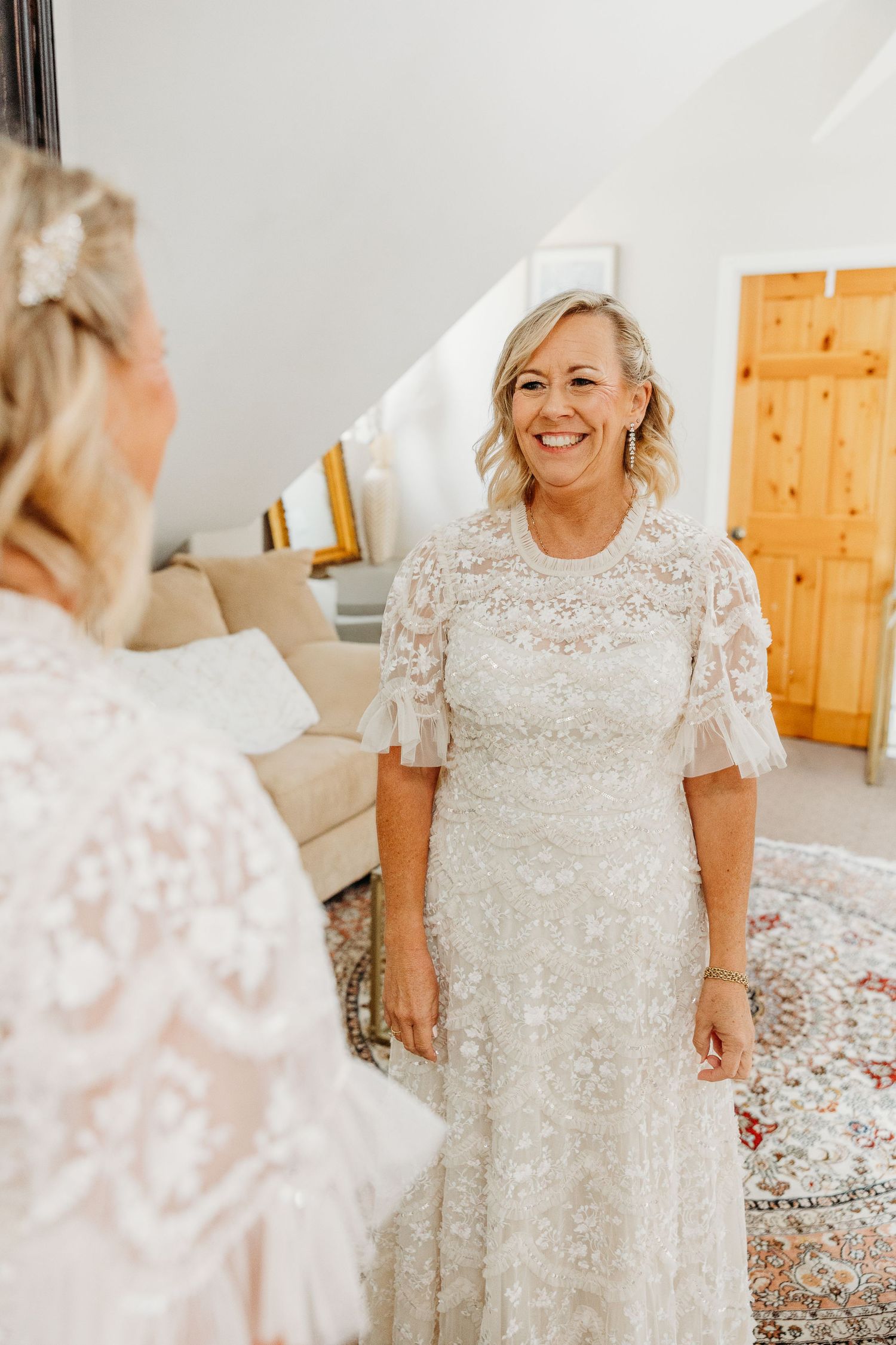 Lace wedding dress with delicate short sleeves and intricate beading details.