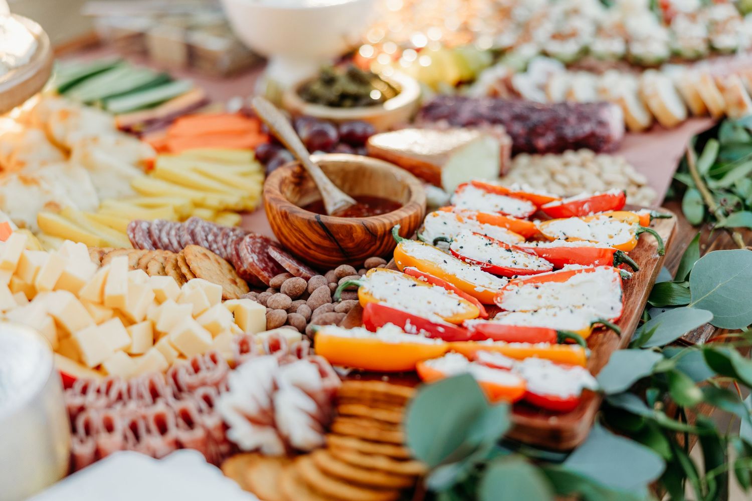 Overhead view of a gourmet charcuterie board with meats, cheeses, and appetizers.