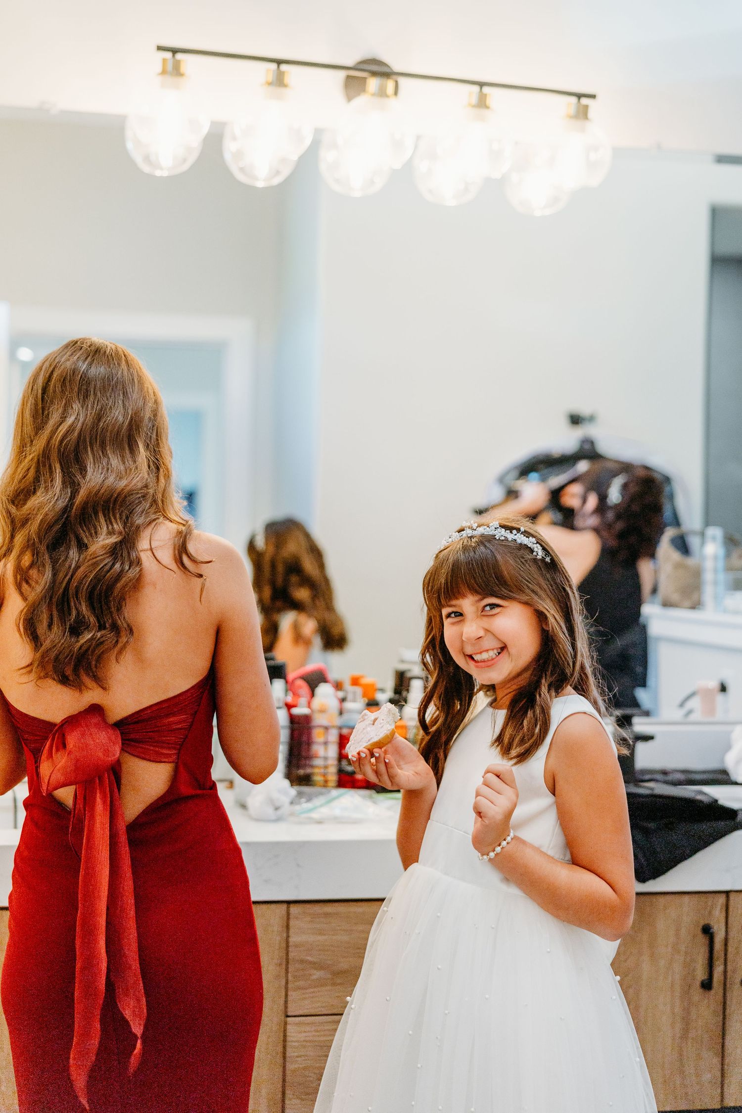 A sequence of candid moments showing a young girl in a white dress and woman in red dress sharing joyful interactions.