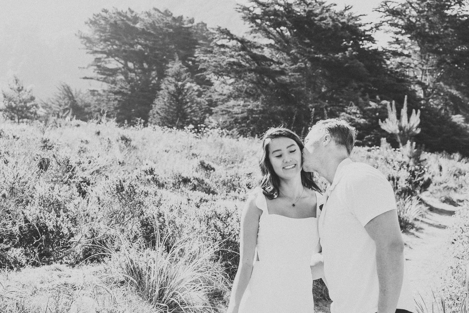 Black and white portrait of couple in natural outdoor setting.