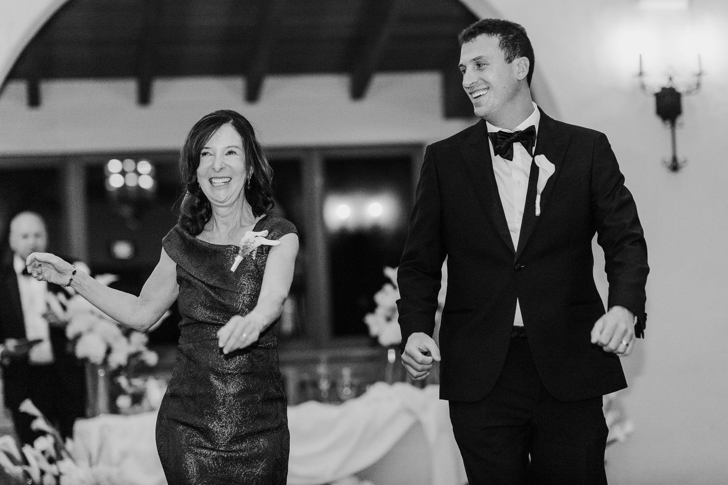 Wedding guests enjoying a dance celebration in an elegant indoor venue.