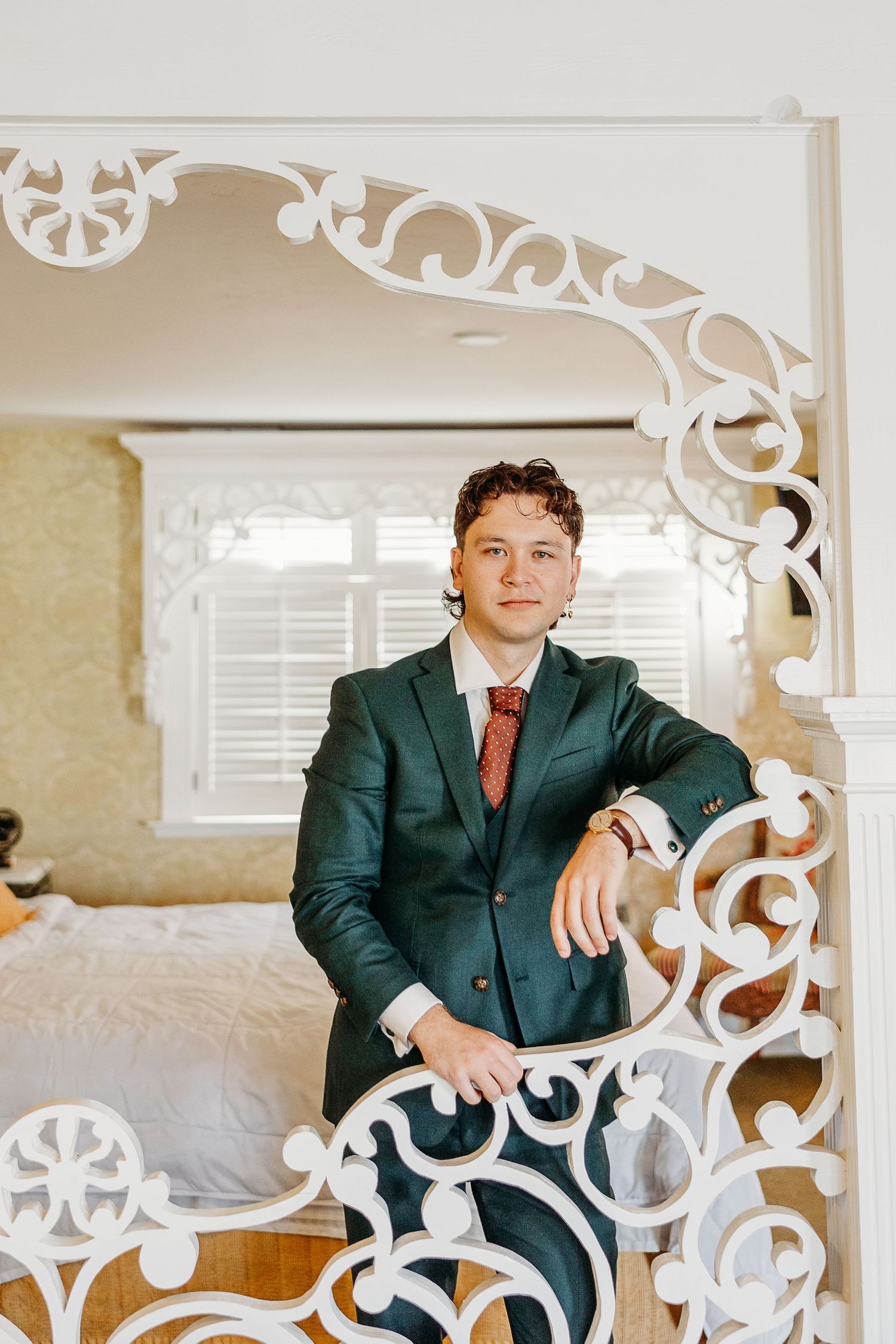 Elegant white decorative frame surrounds a formal scene in an indoor setting.