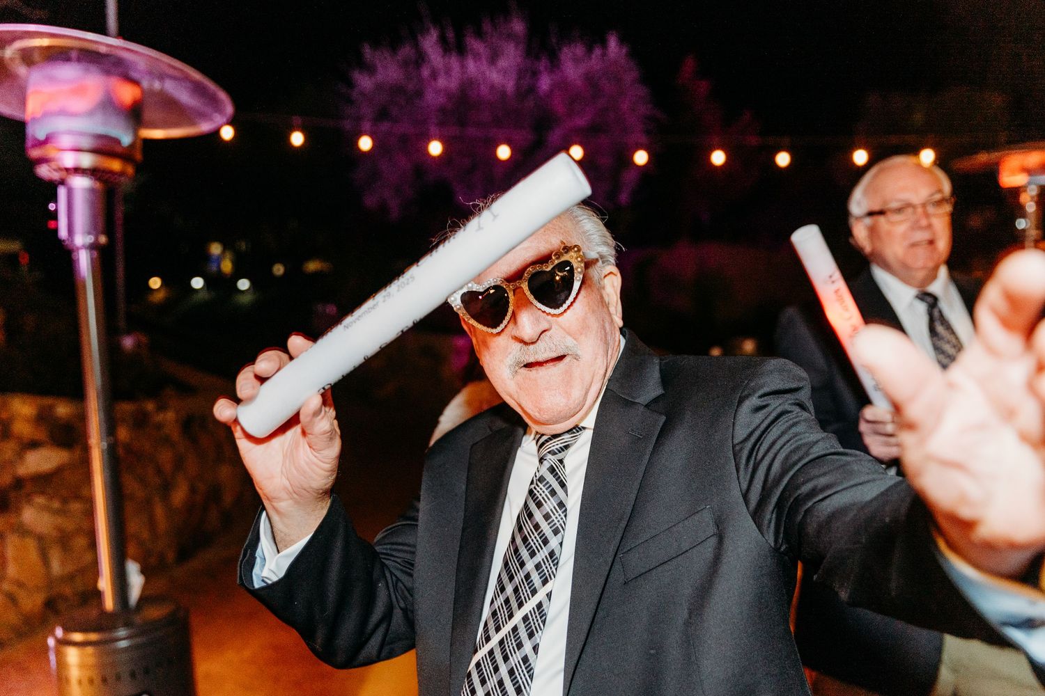 Lively dance party moments captured during nighttime wedding reception.