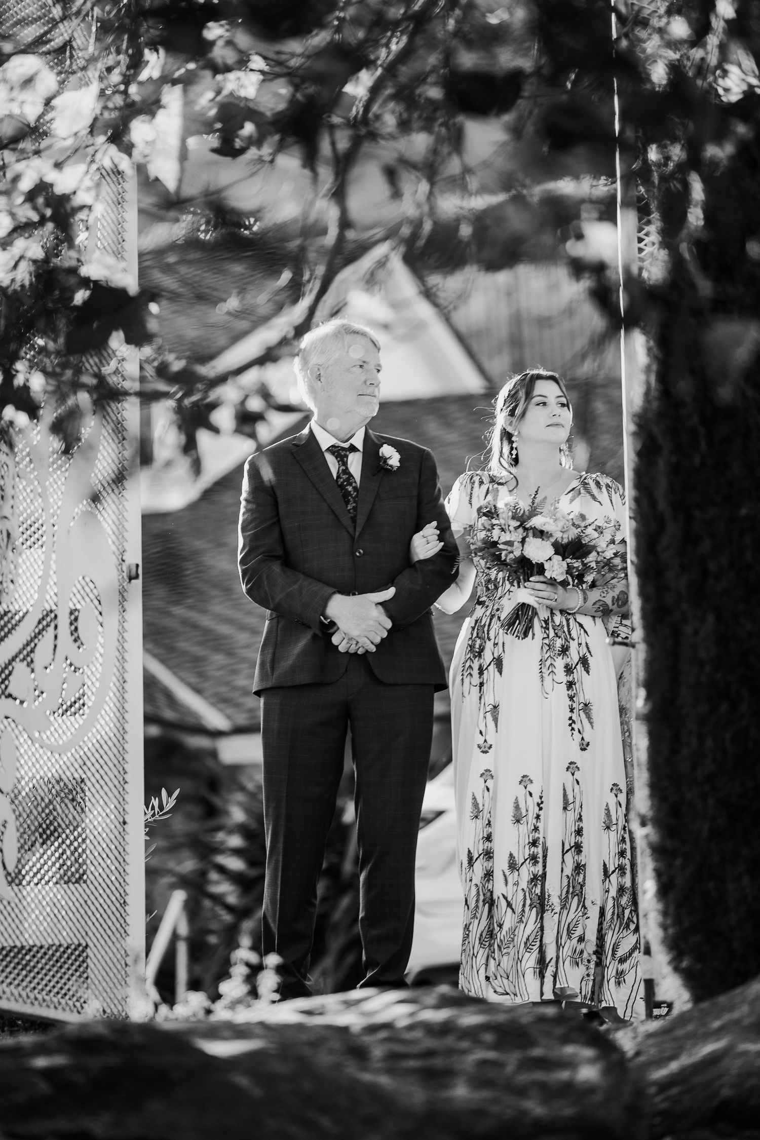 Black and white wedding ceremony photos with decorative lattice backdrop in outdoor setting.