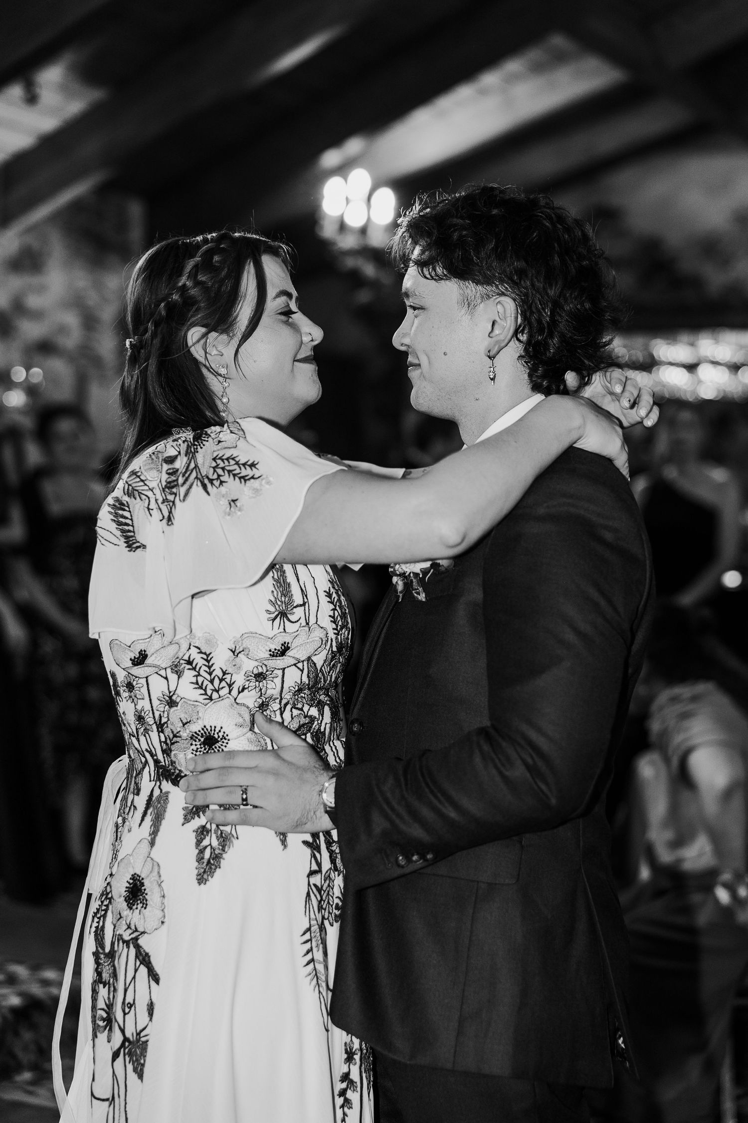 Black and white photo of a romantic first dance at a wedding reception.