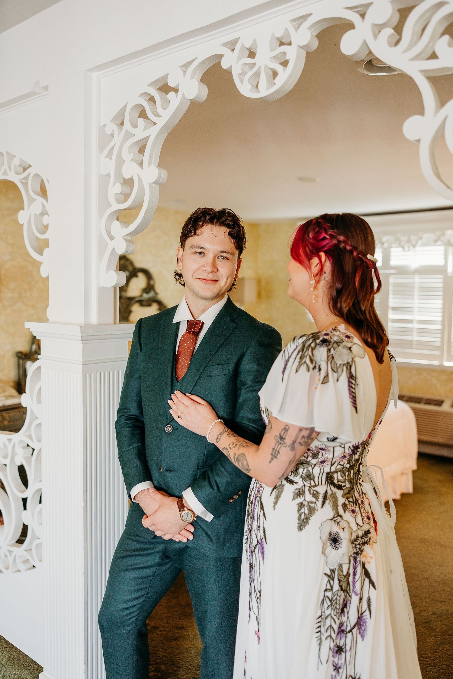 Wedding venue photos showing ornate white architectural details and formal attire.