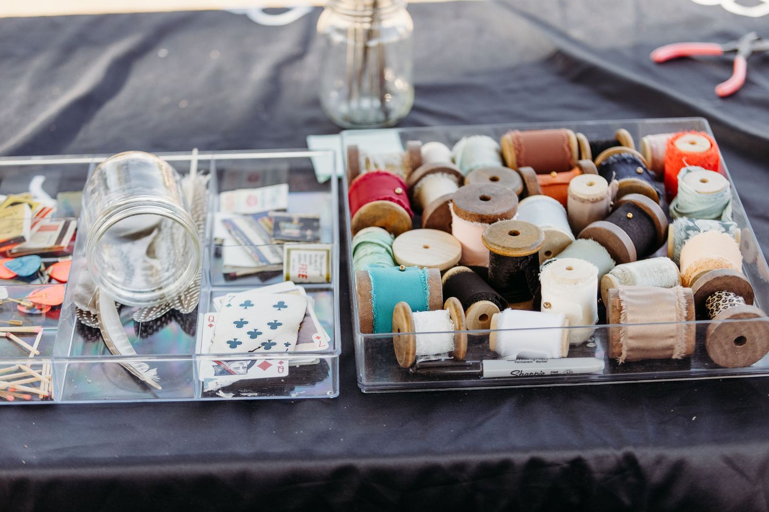 Wedding accessories and details displayed on a dark blue tablecloth.