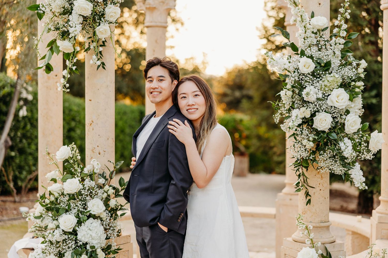 Romantic outdoor wedding ceremony setup in Paso Robles with white floral decorations at golden hour in the garden of the Allegretto Resort