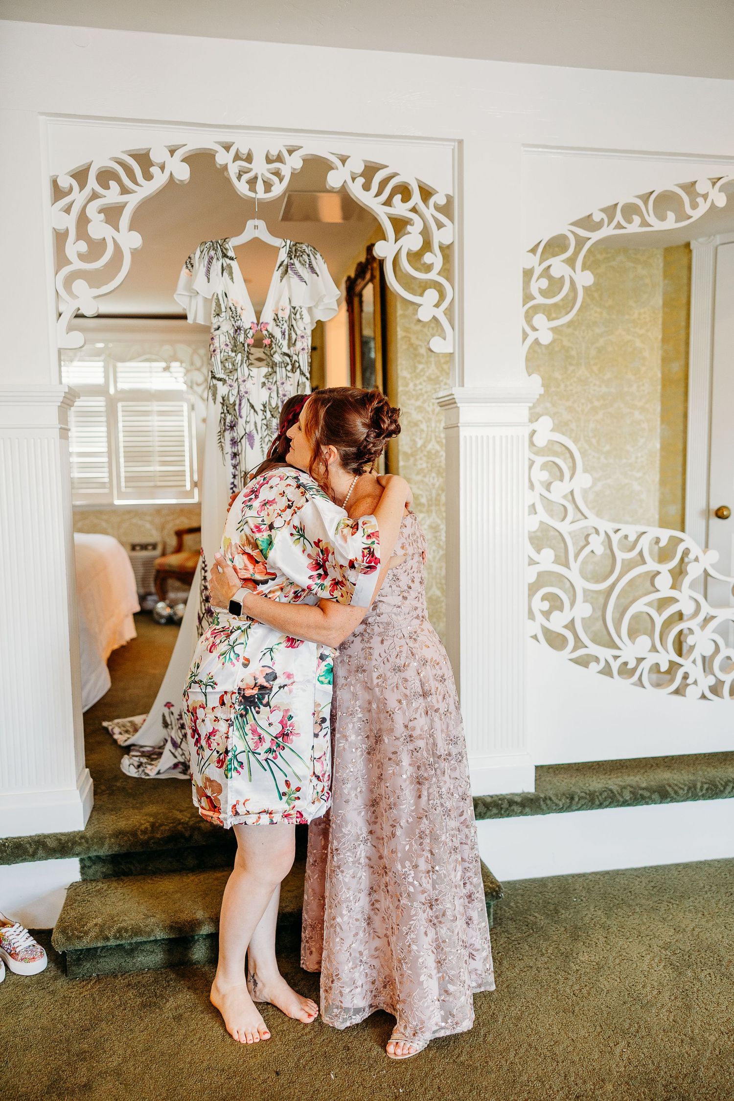 Wedding preparations showing floral robes and ornate white decorative wall panels.
