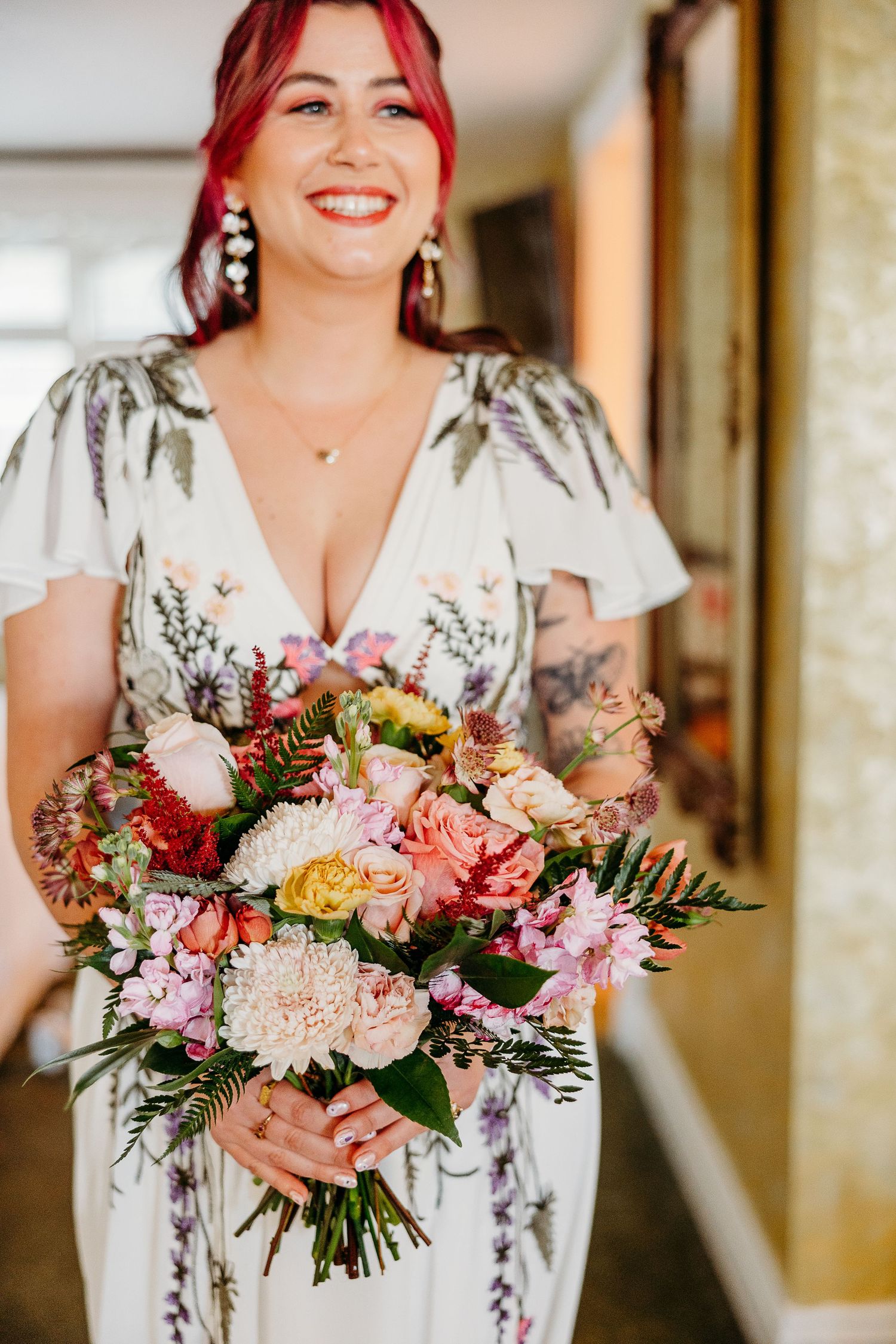 A joyful moment captured with vibrant floral bouquets and a floral print dress.