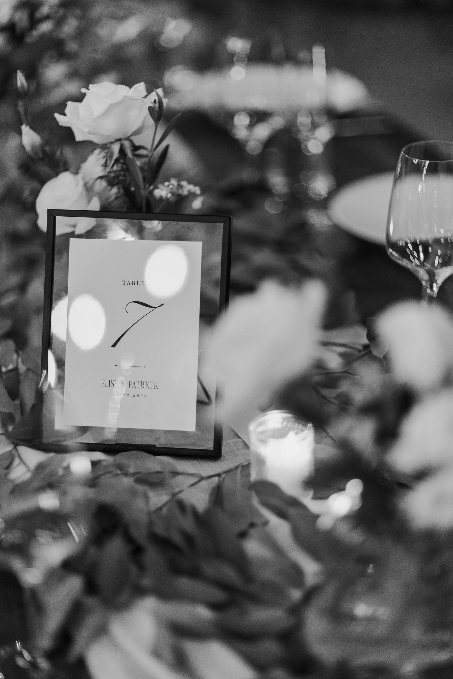 Black and white detail shot of elegant wedding table numbers in decorative frames.