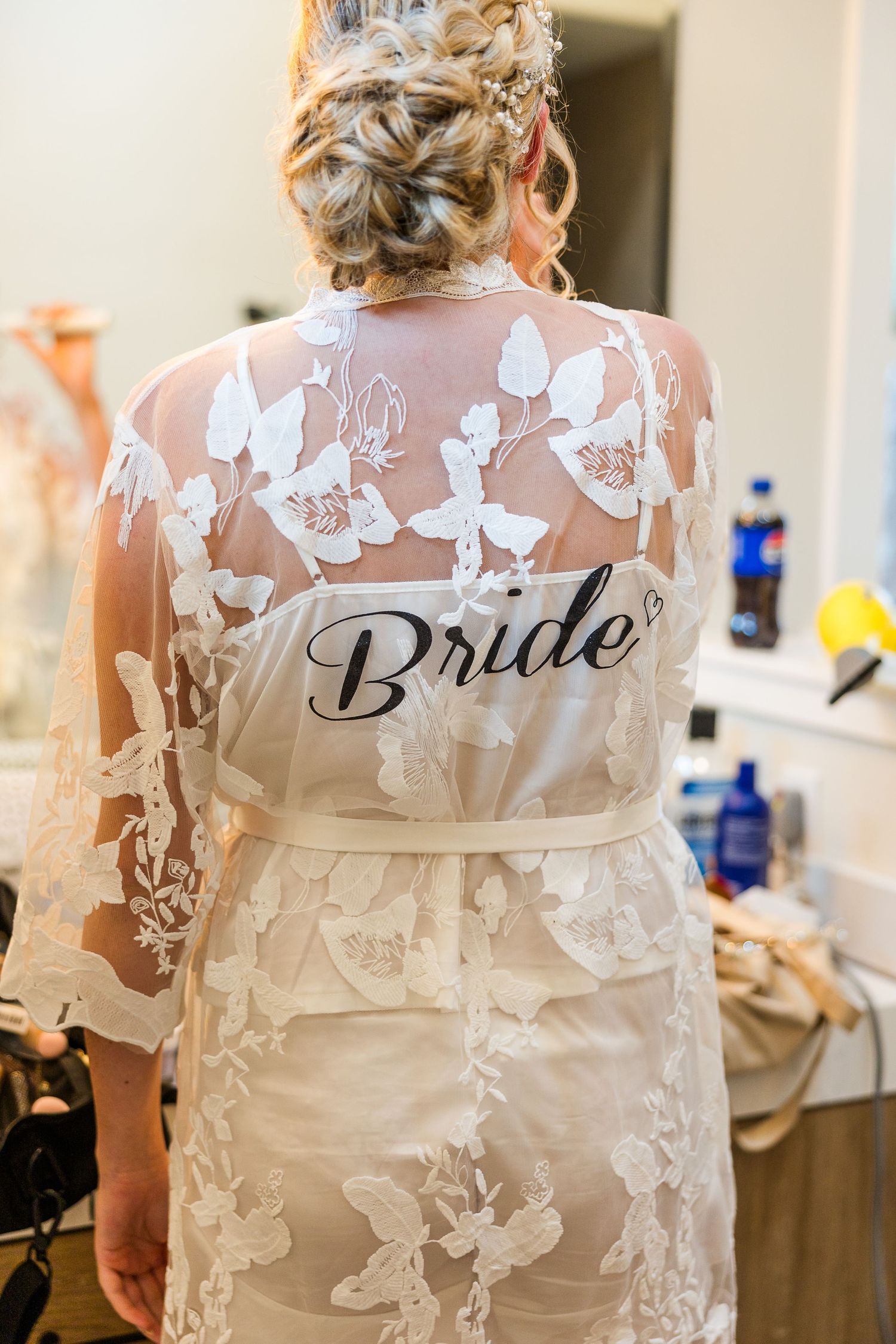 Detail shot of sheer floral bridal robe with 'Bride' text on back.