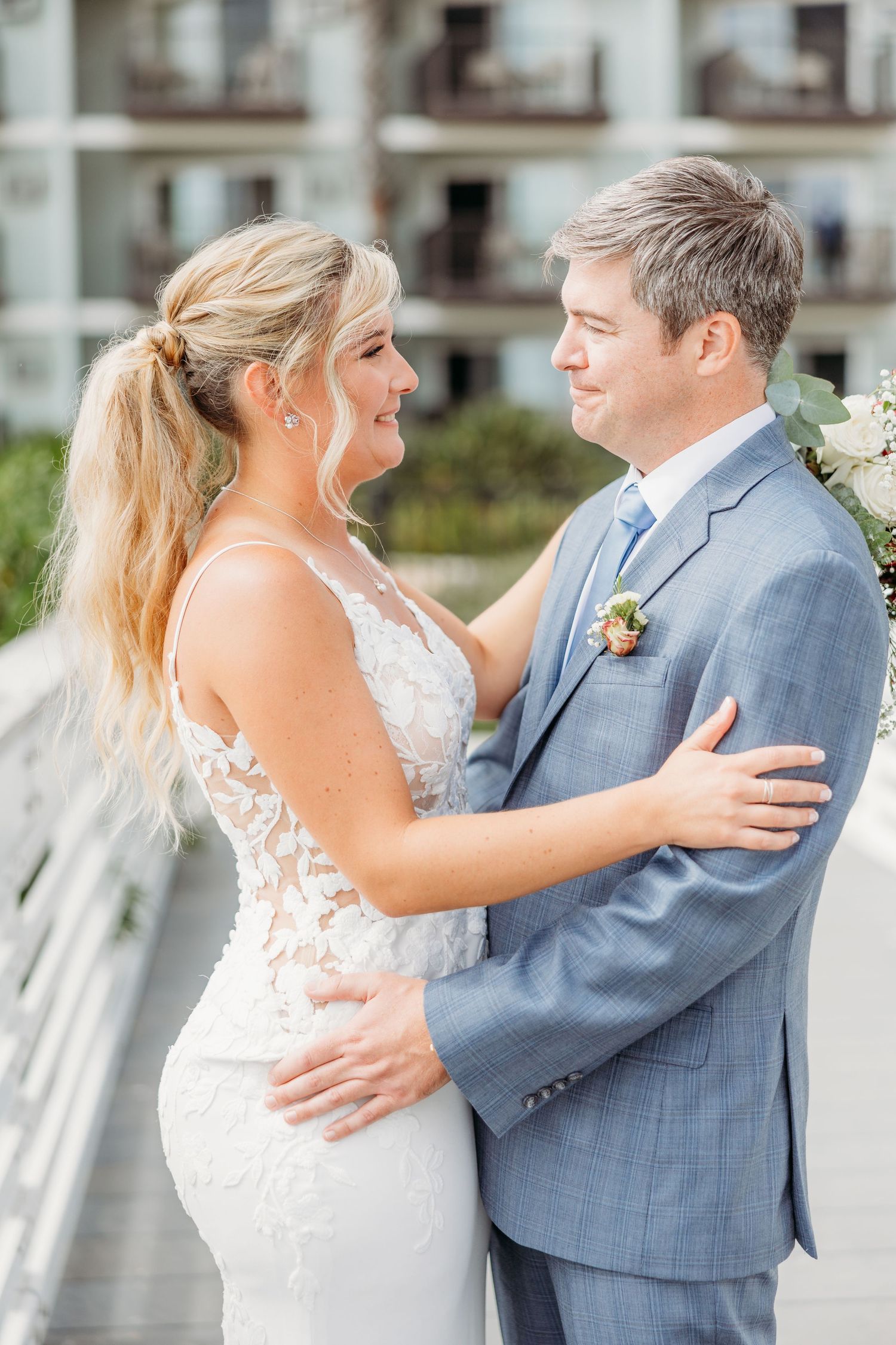 Romantic embrace captured during coastal wedding photoshoot.