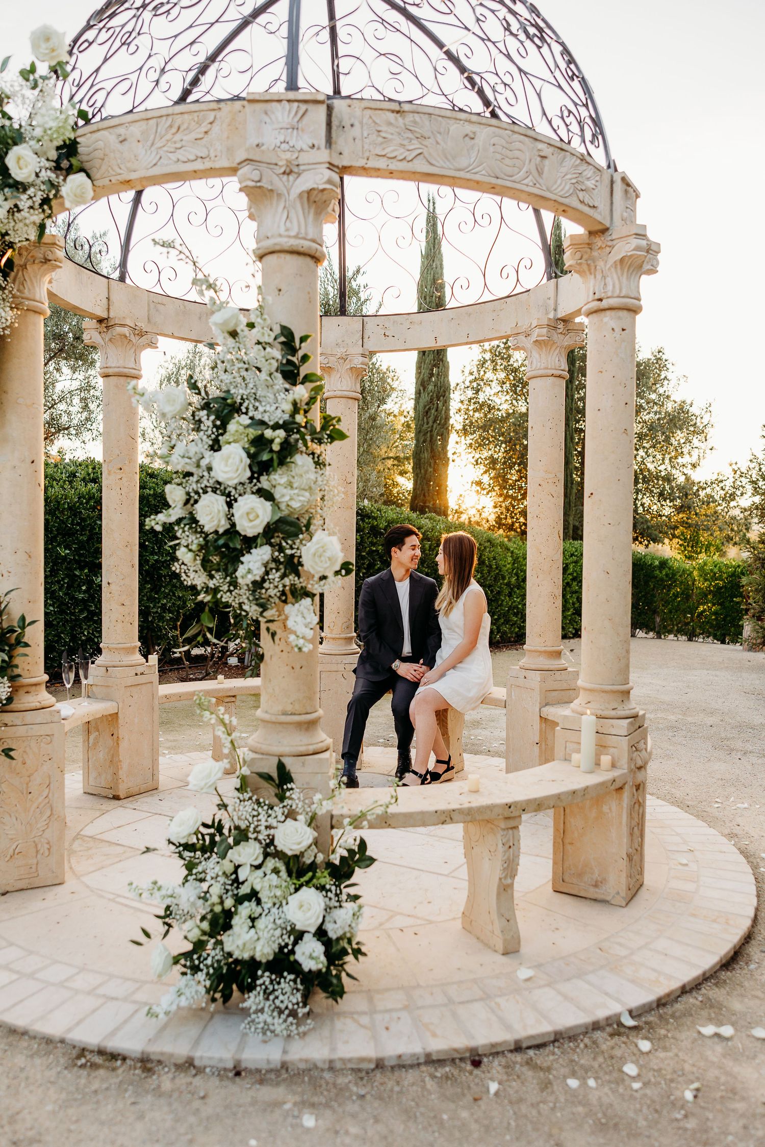Couple embracing under the floral gazebo at Allegretto Vineyard Resort