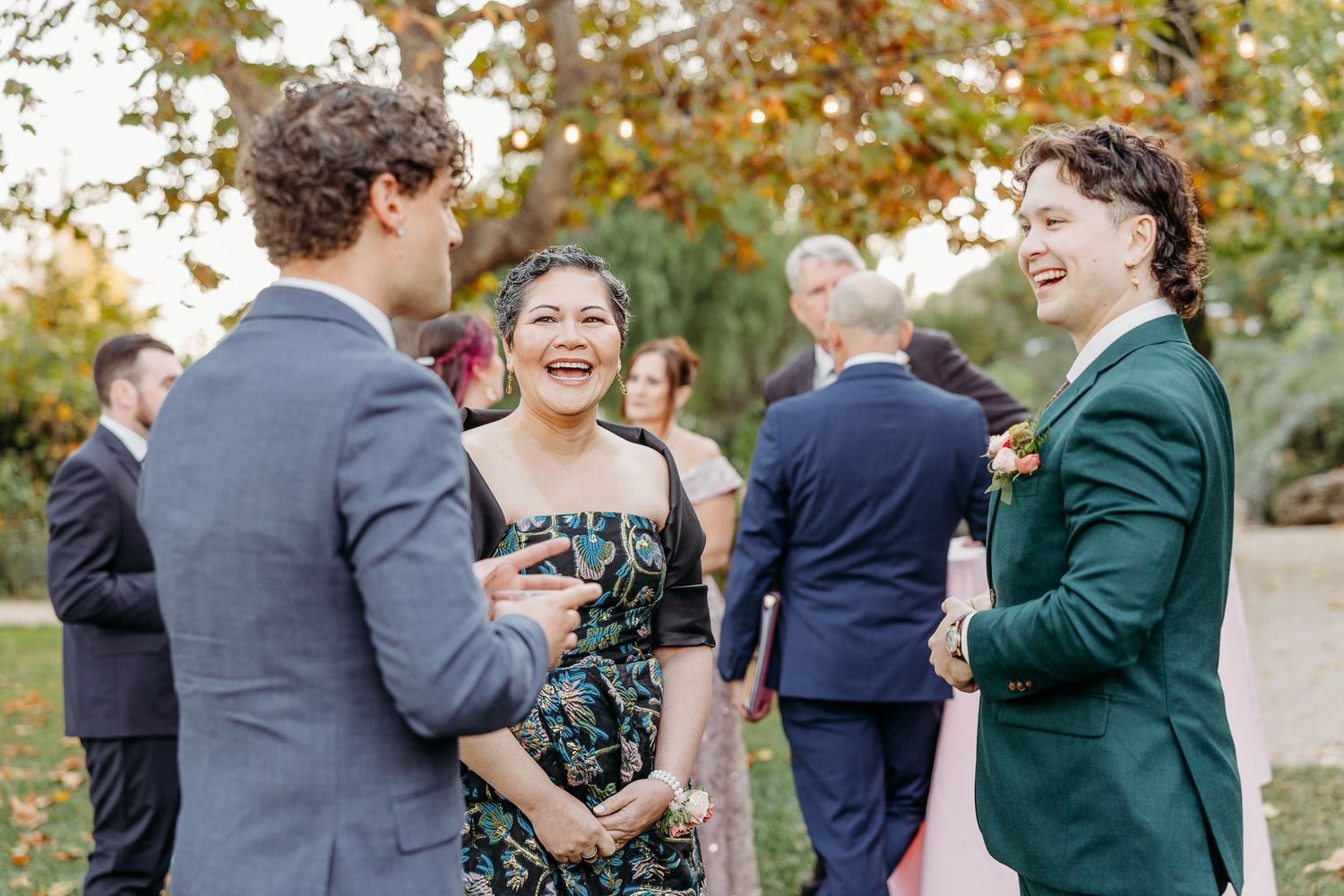 Wedding guests mingle and socialize during an outdoor autumn reception.