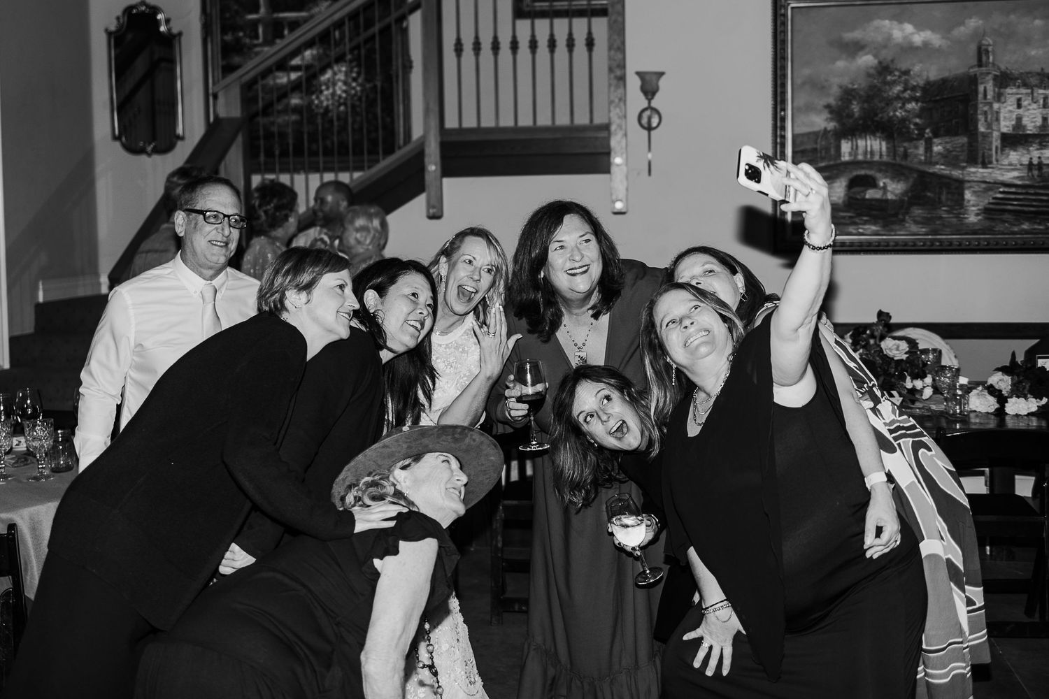 Group of friends posing together at party in black and white photography.