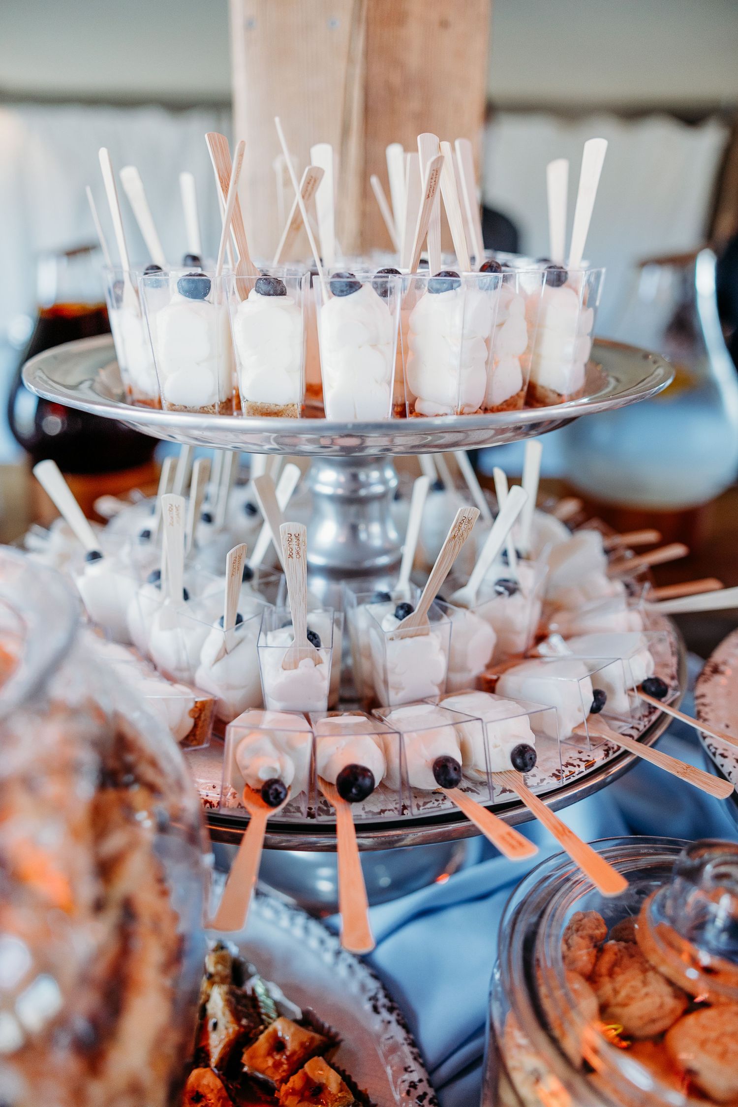 Tiered display of dessert shooters with blueberries and straws on silver platters at Holland Ranch San Luis Obispo