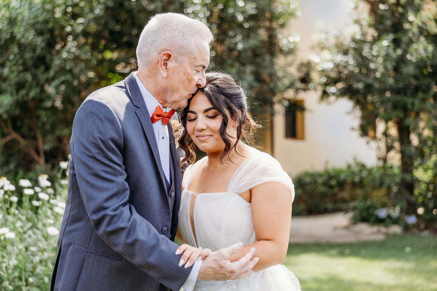 A tender moment between a couple during their garden wedding celebration.