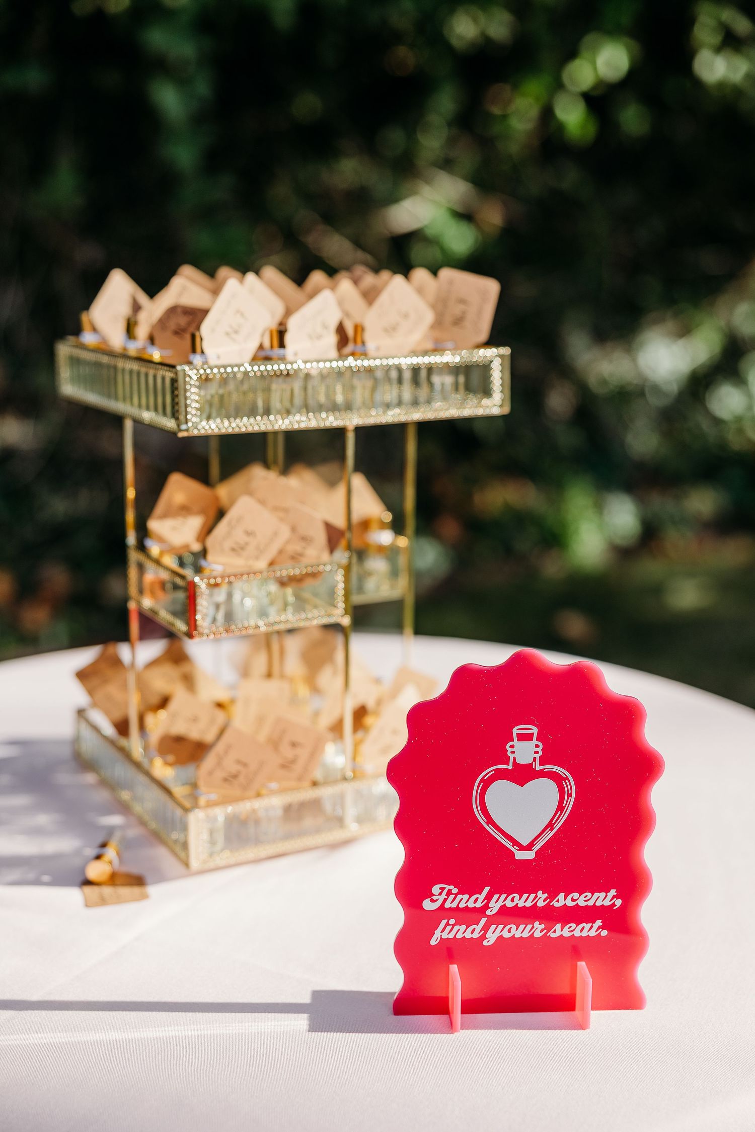 Red heart-shaped seating cards displayed on a white table with gold decor elements.
