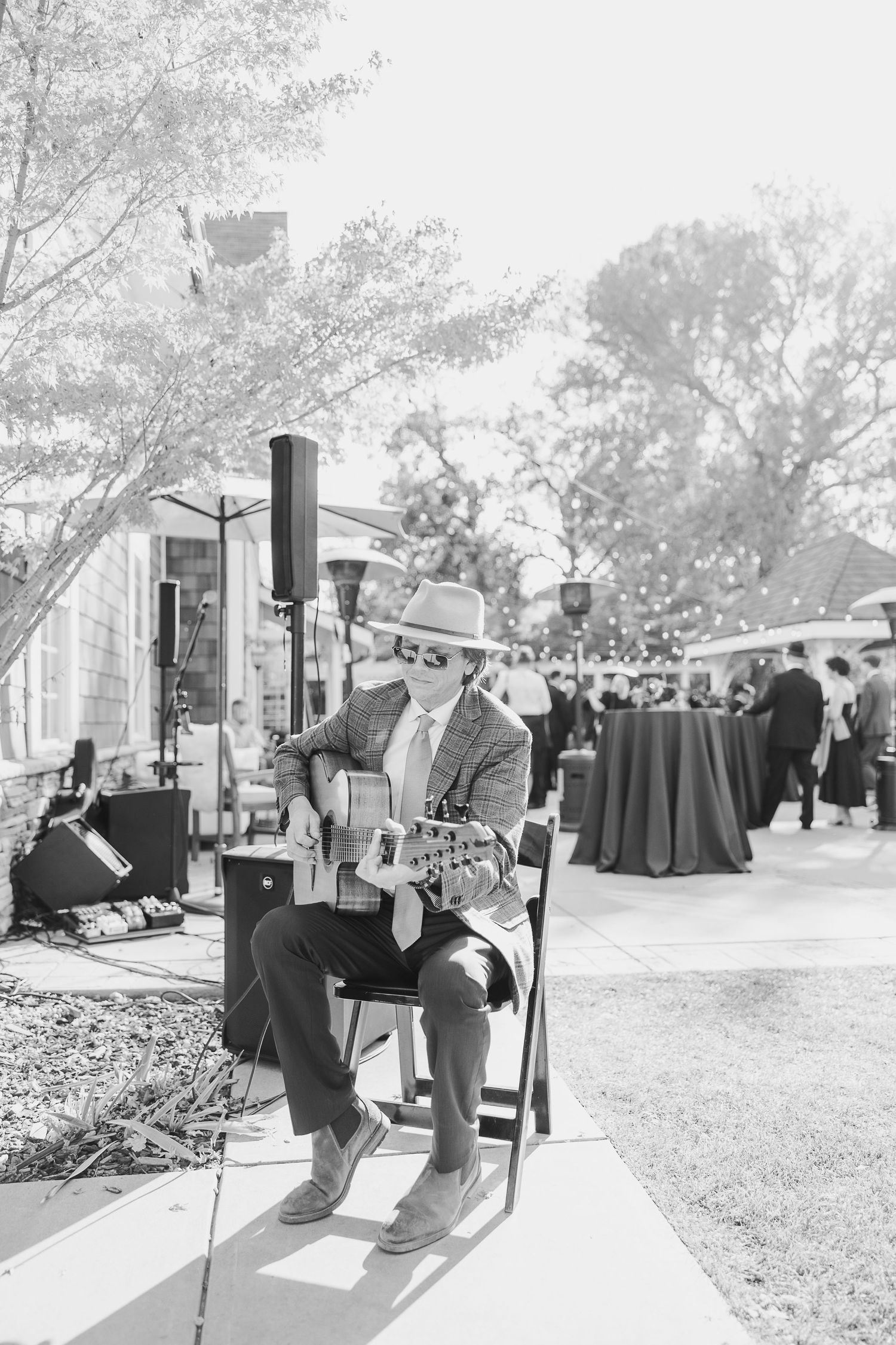 Black and white photos of guests sitting on benches at an outdoor event.