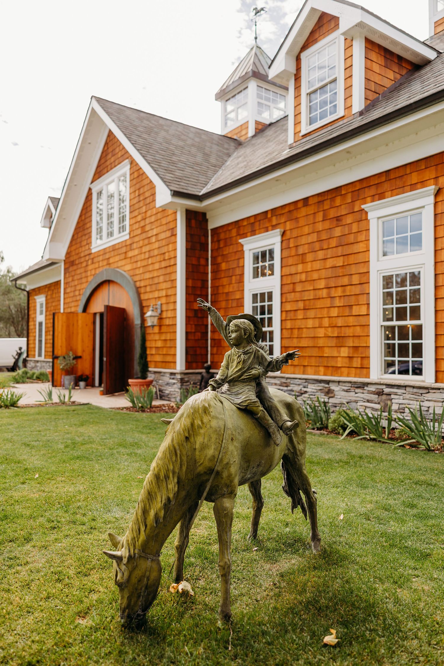 Rustic cedar shake house exterior with white trim and multiple windows showcases classic New England architecture.
