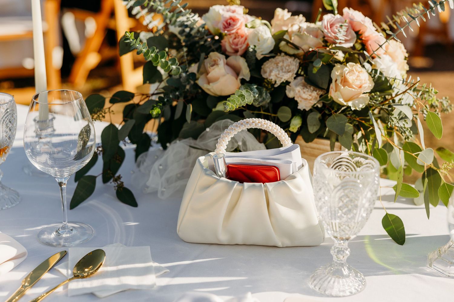 Elegant wedding reception table decorated with white and pink floral arrangements.