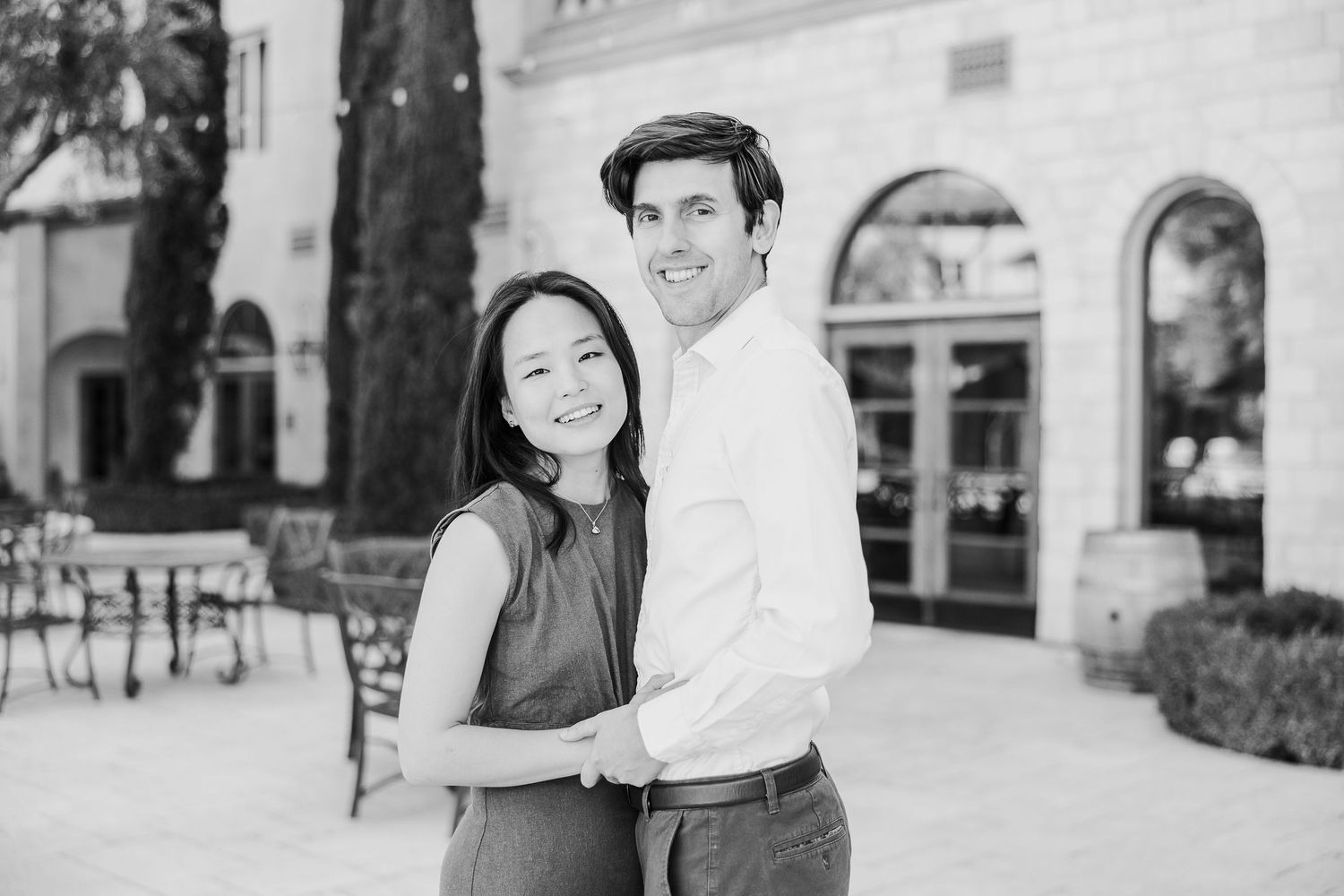 Black and white wedding photo collage showing intimate moments between a couple at an elegant venue.