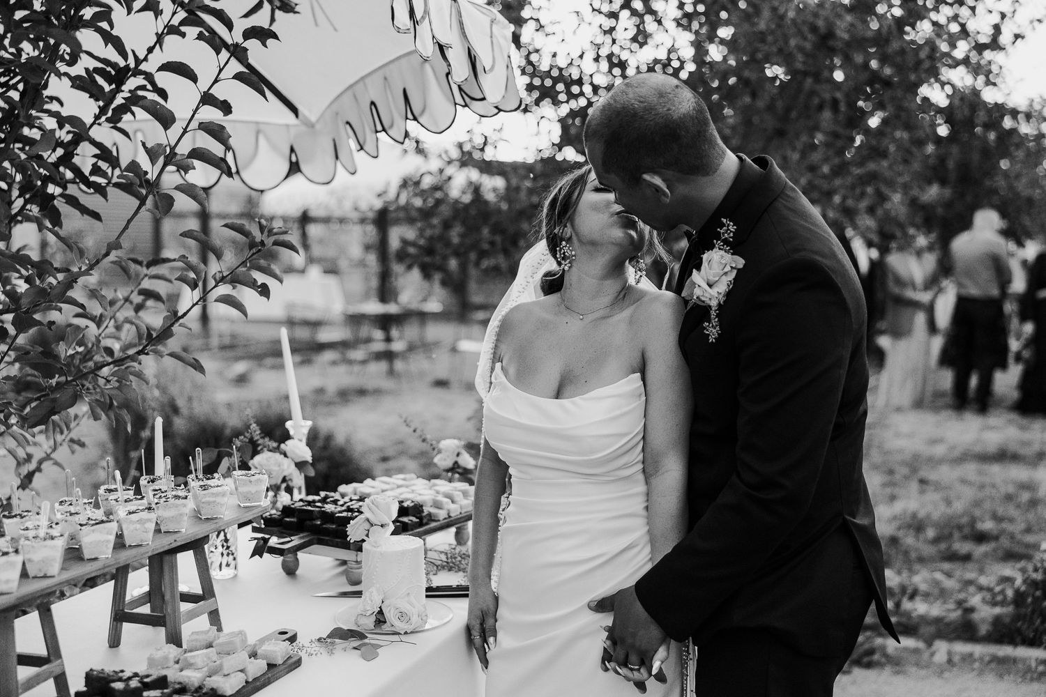 Black and white candid wedding moments captured outdoors.