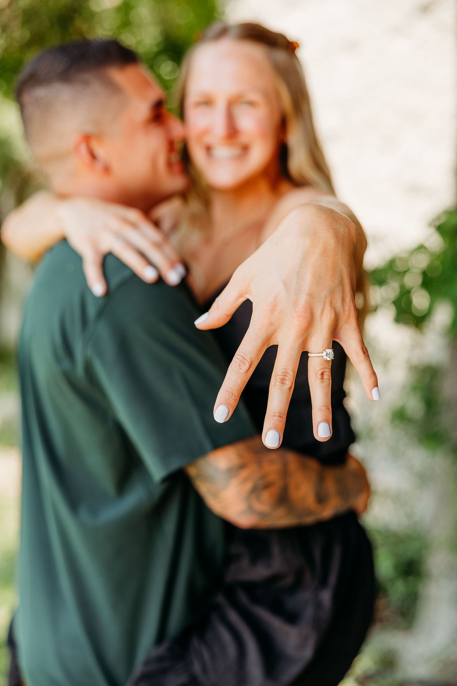 Close-up series showing an engagement ring on a hand with a blurred romantic embrace in the background.