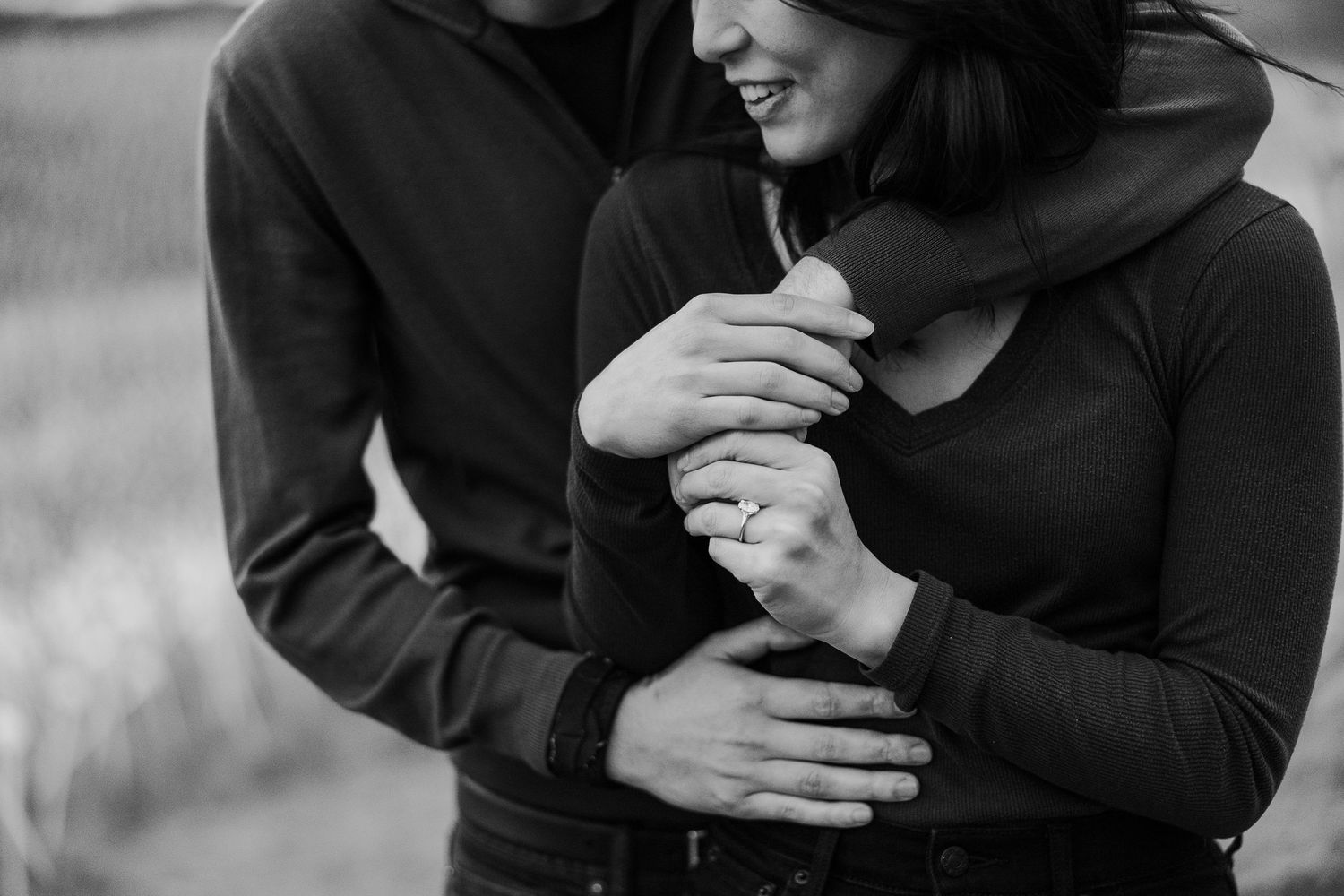A couple shares a joyful moment together while embracing outdoors.