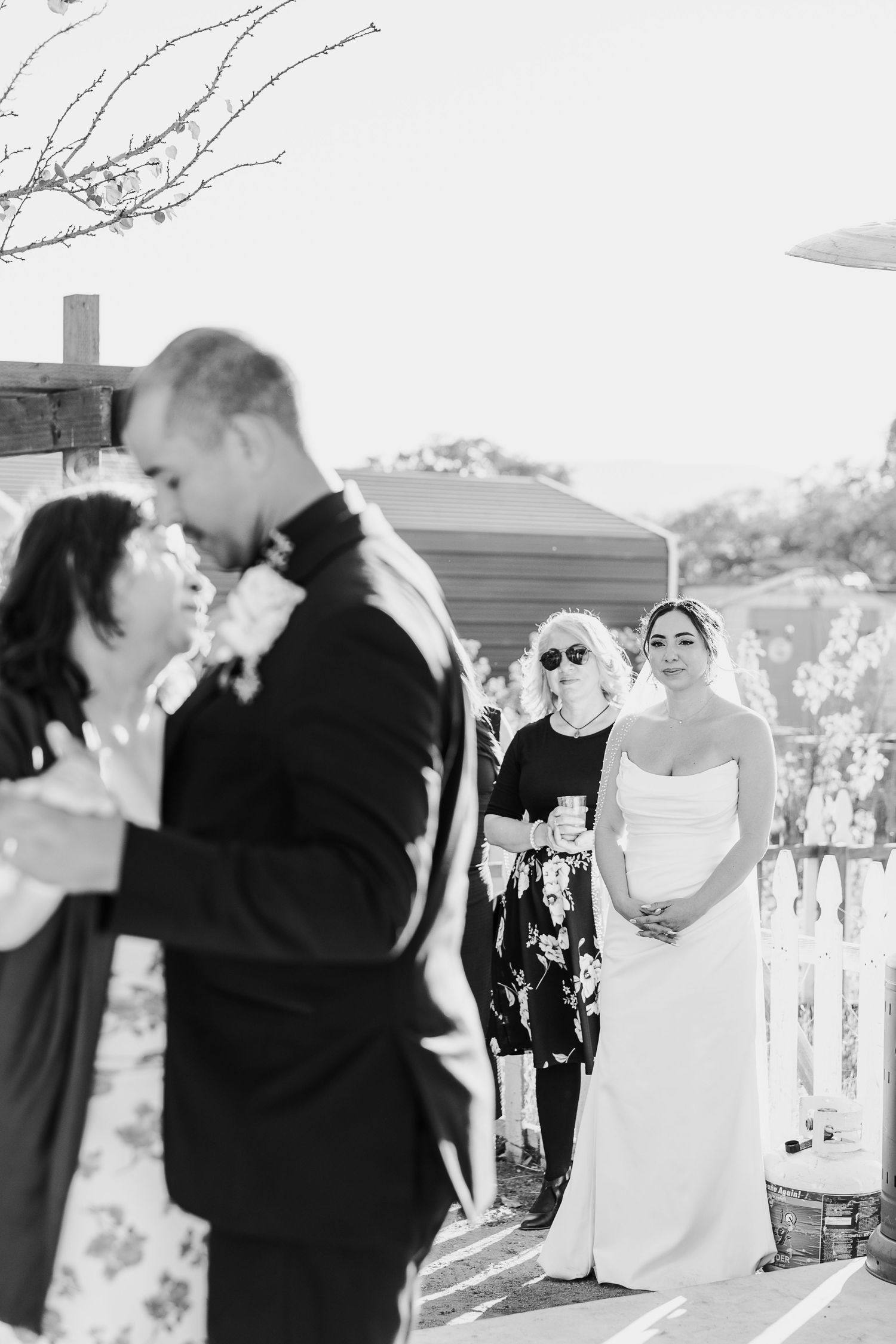 Black and white photo of a wedding ceremony with guests watching the couple.