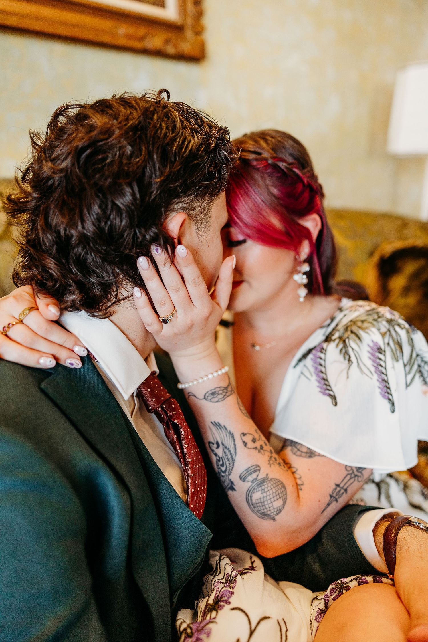 Intimate wedding moment between couple with visible neck tattoos.