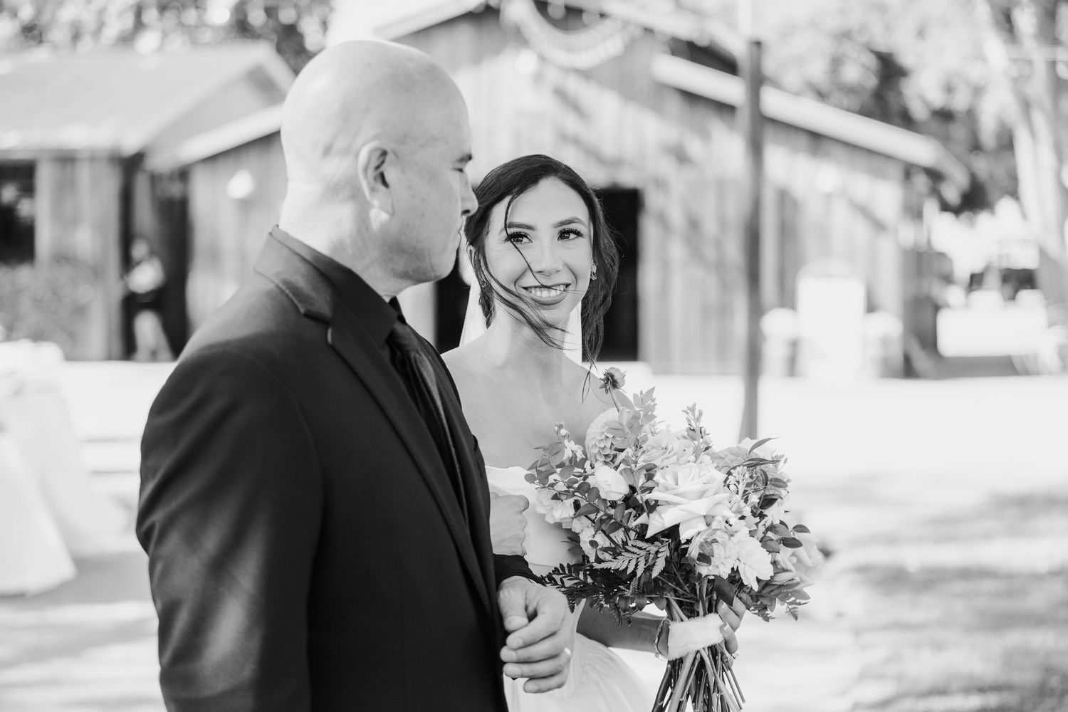 Black and white romantic outdoor wedding photos with soft natural lighting.