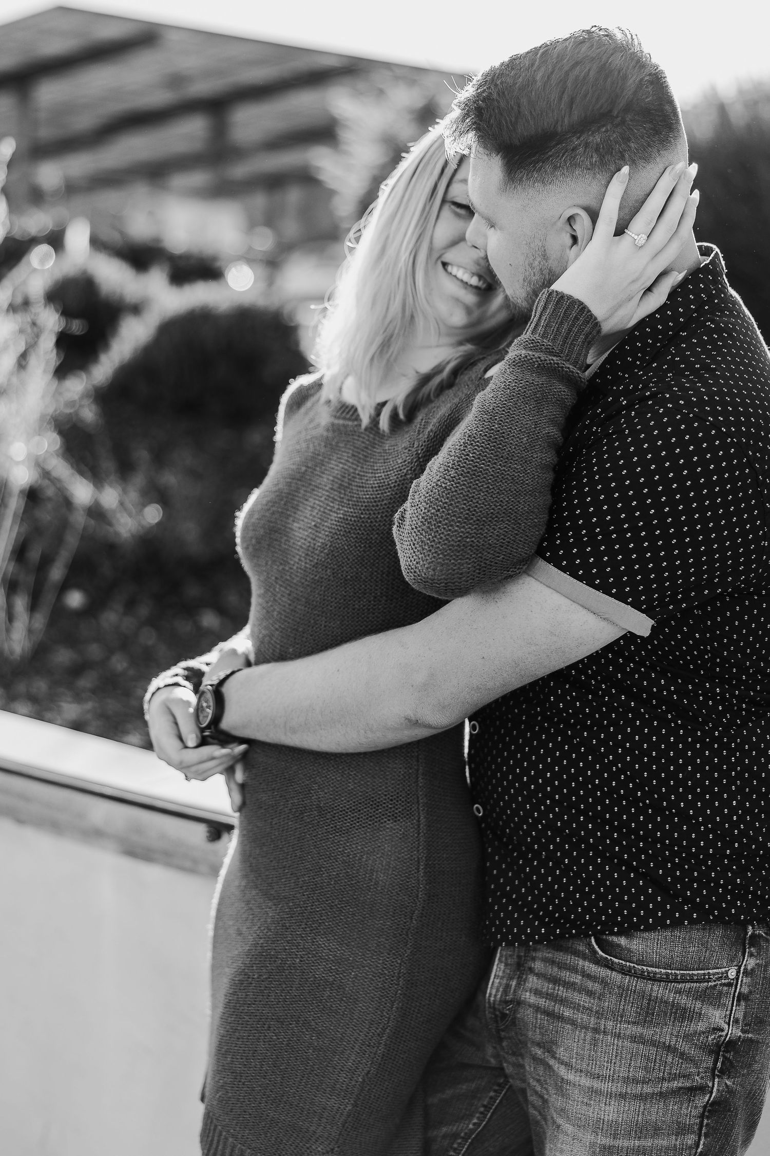 A black and white portrait captures an intimate moment between a couple.