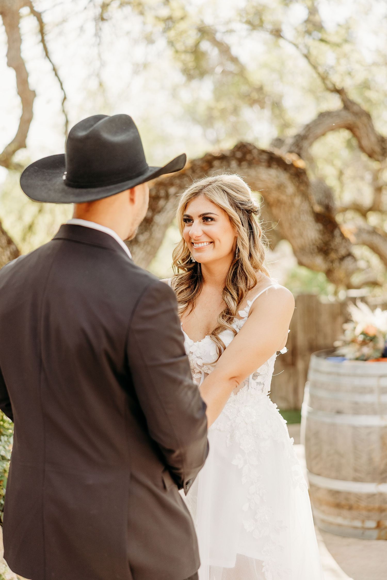 A heartfelt moment between a couple during their rustic-themed wedding celebration.