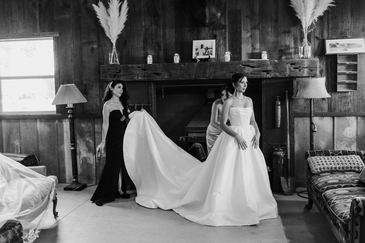 A series of black and white wedding photos showing a bride in a flowing white gown in various rustic indoor settings.