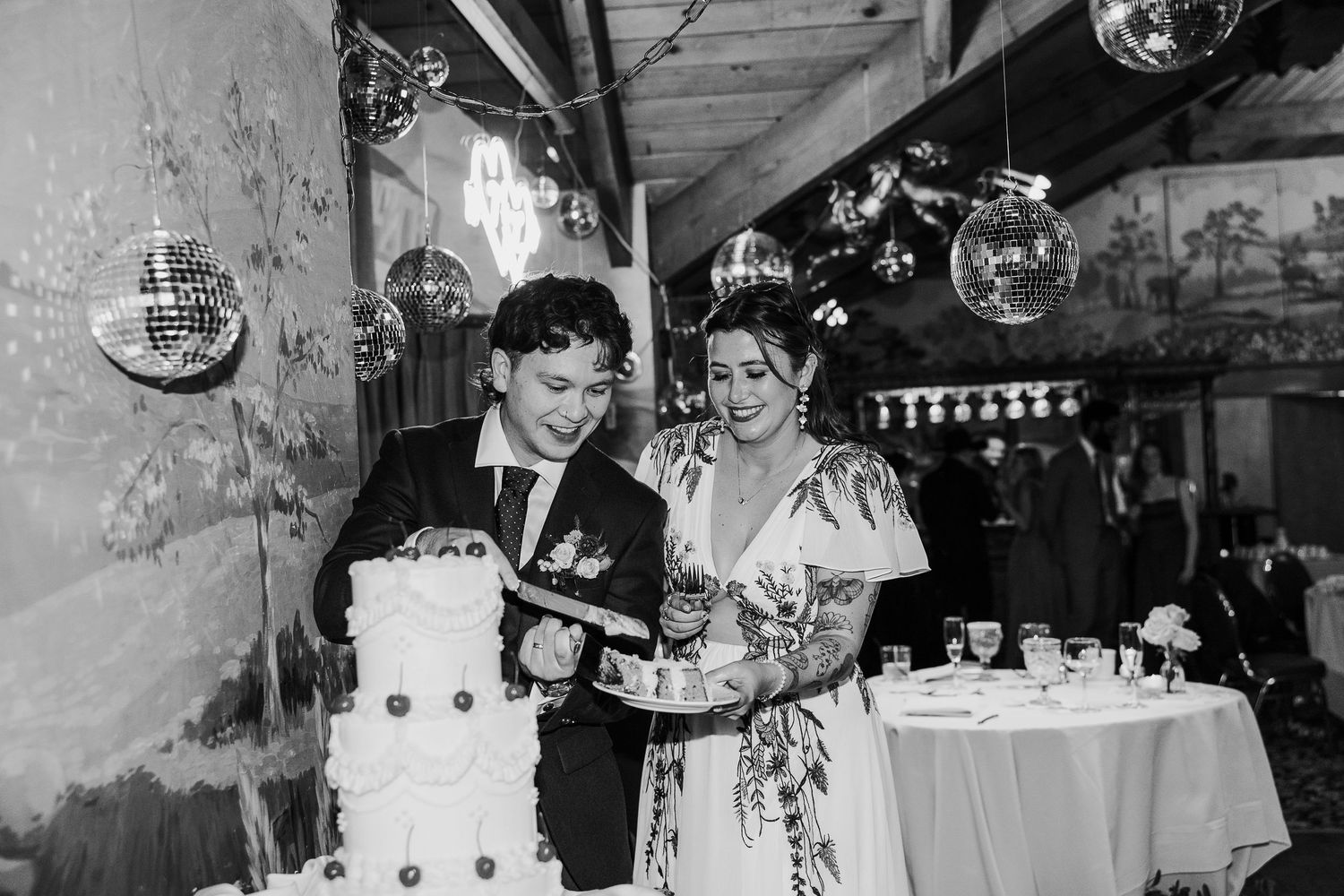 Wedding reception venue with disco balls and vintage industrial decor.