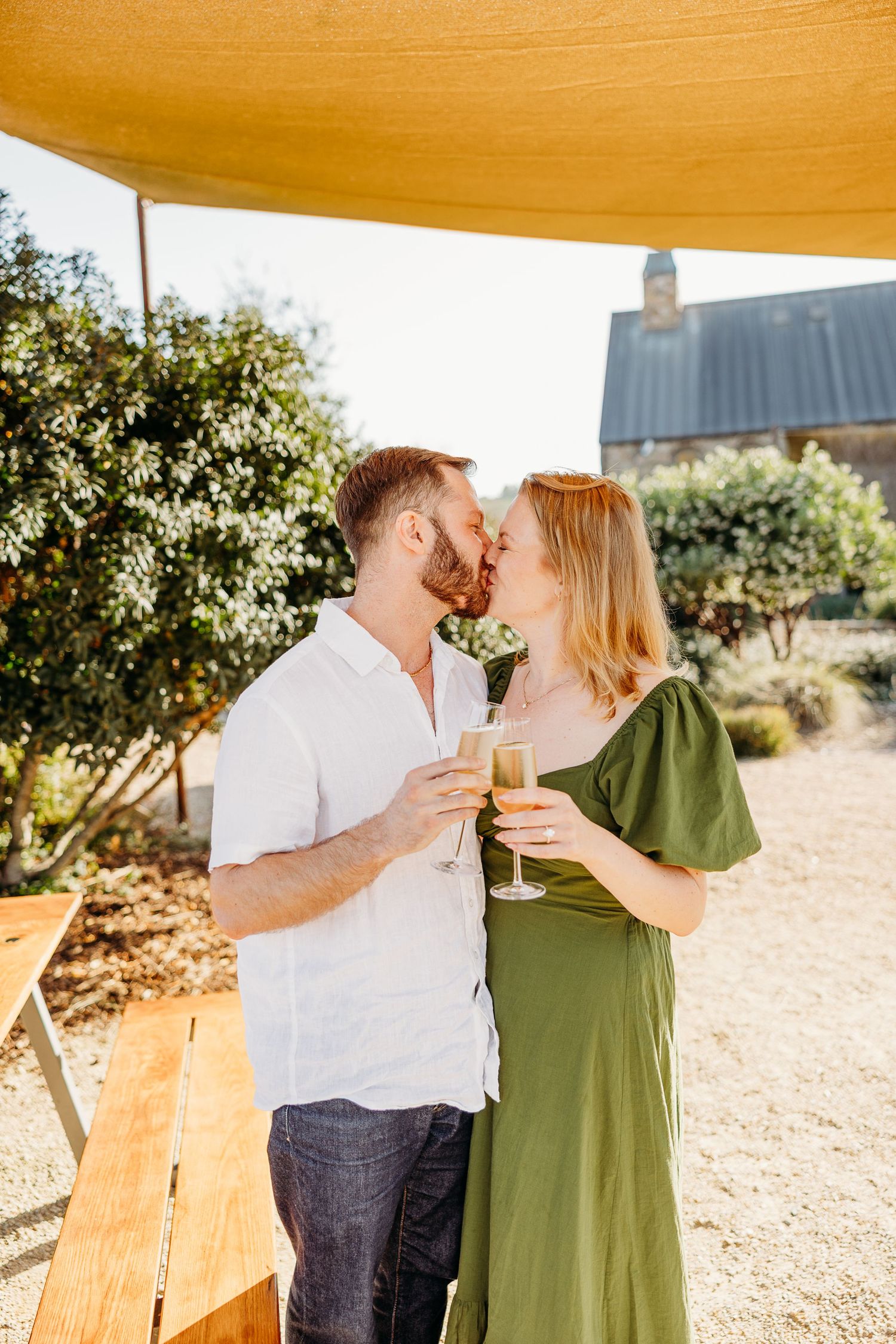 A romantic celebration with champagne at an outdoor winery patio.